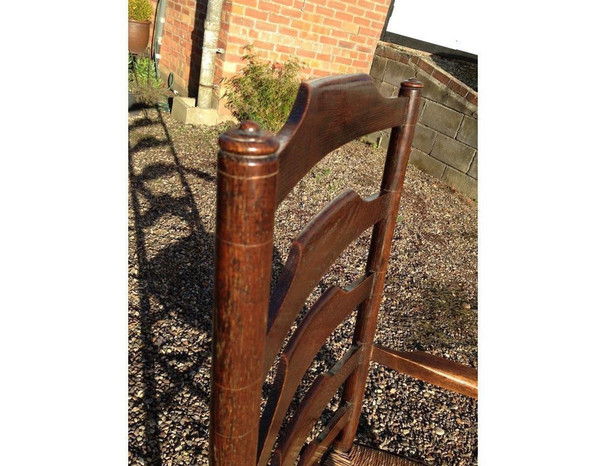 An English Cotswold School Oak Ladder Back Rush Seat Armchair photo vinterior