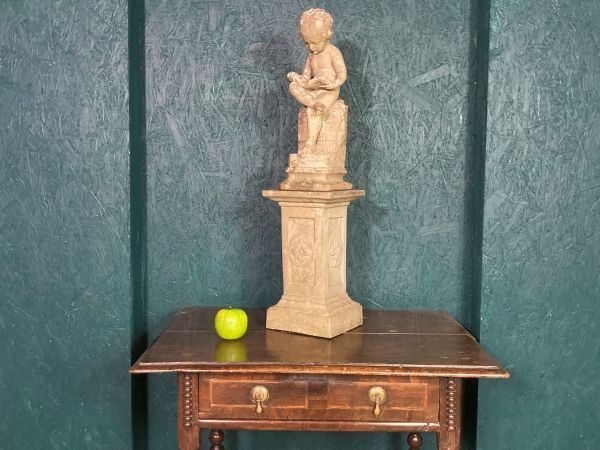 A Fine Petite Stoneware Sculpture Of A Seated Cherub