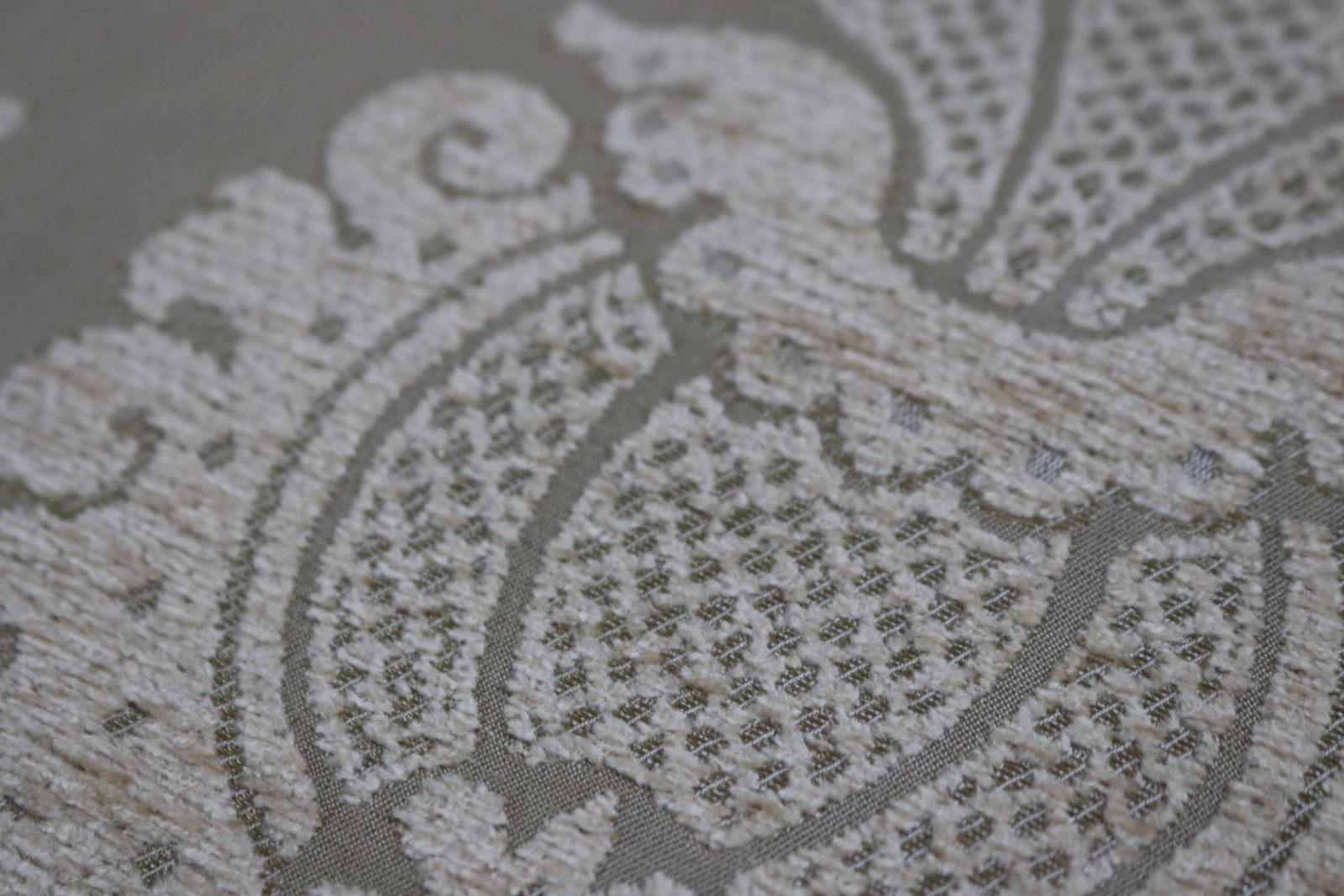 Textiles Roll Of Gold Fabric With A Decorative Design photo