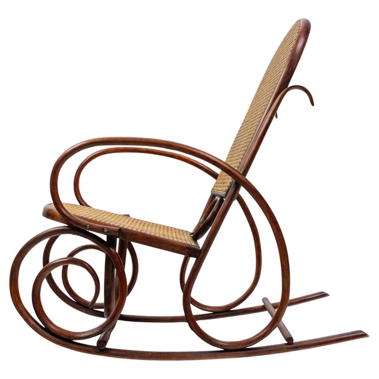 Rocking Chair In Turned Wood, Canework, Early 20th Century.