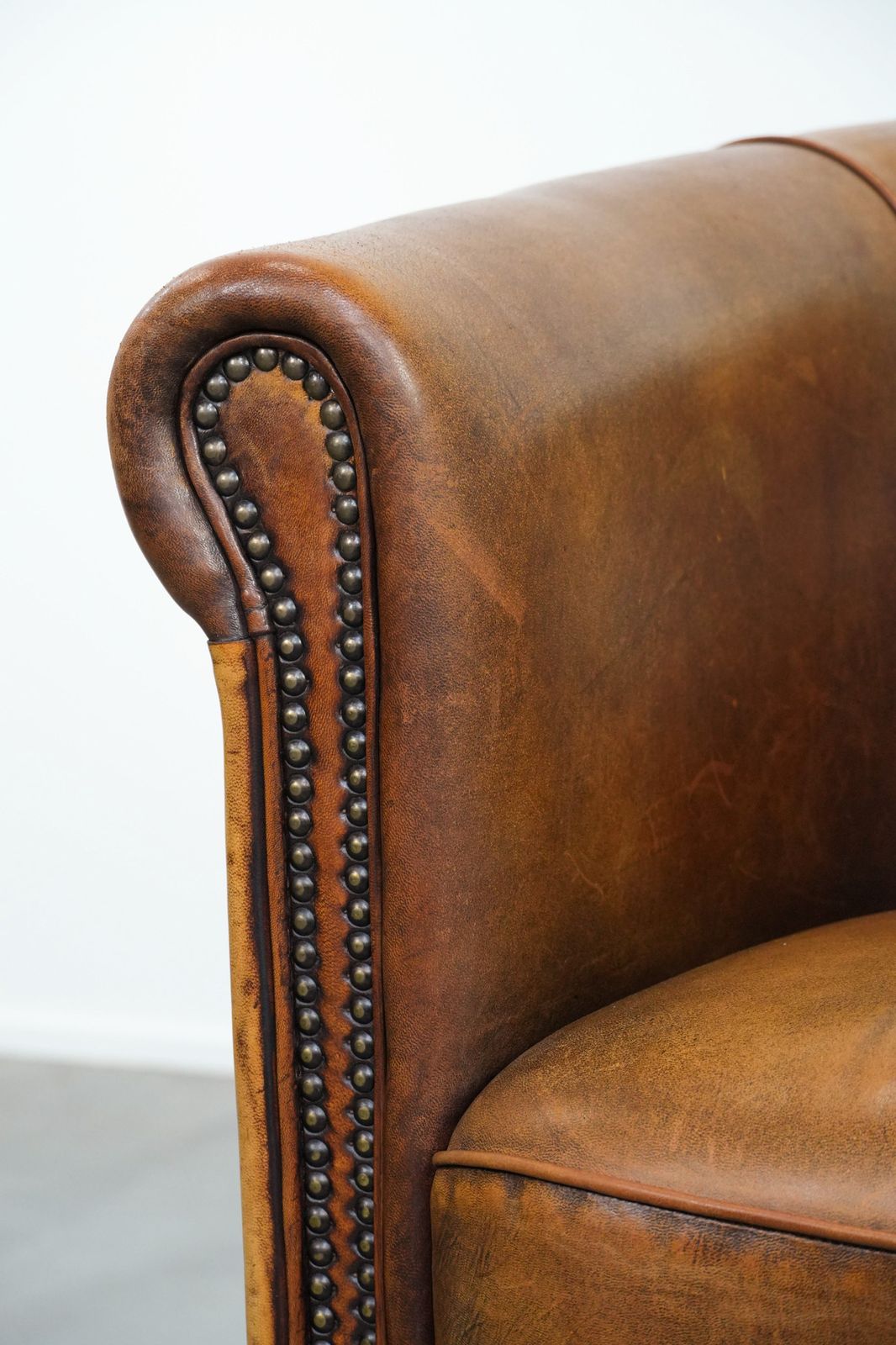 photo for sale Elegant Sheepskin Club Armchair With Beautiful Warm Colours, A Finish With Decorative Nails And Beautiful Stitching