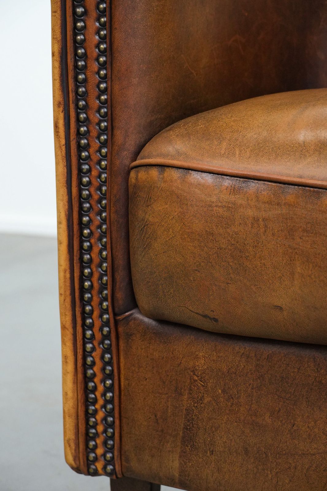 Furniture Elegant Sheepskin Club Armchair With Beautiful Warm Colours, A Finish With Decorative Nails And Beautiful Stitching photo