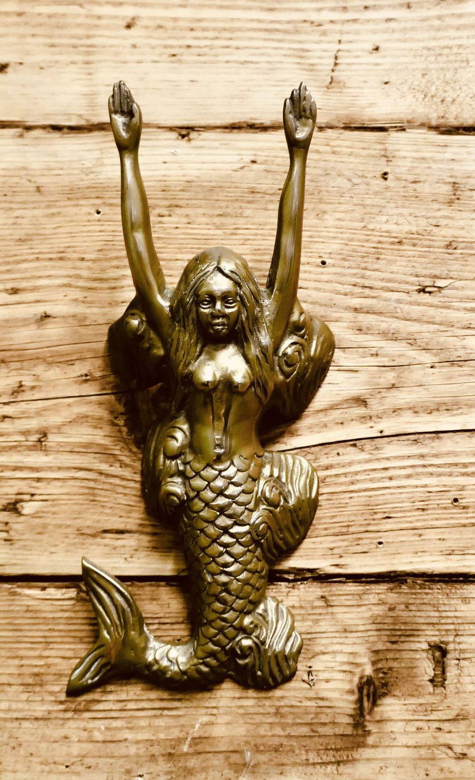 A Brass Door Knocker In The Shape Of A Mermaid photo furniture