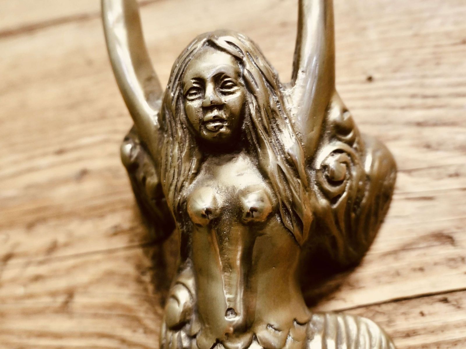 A Brass Door Knocker In The Shape Of A Mermaid photo for sale