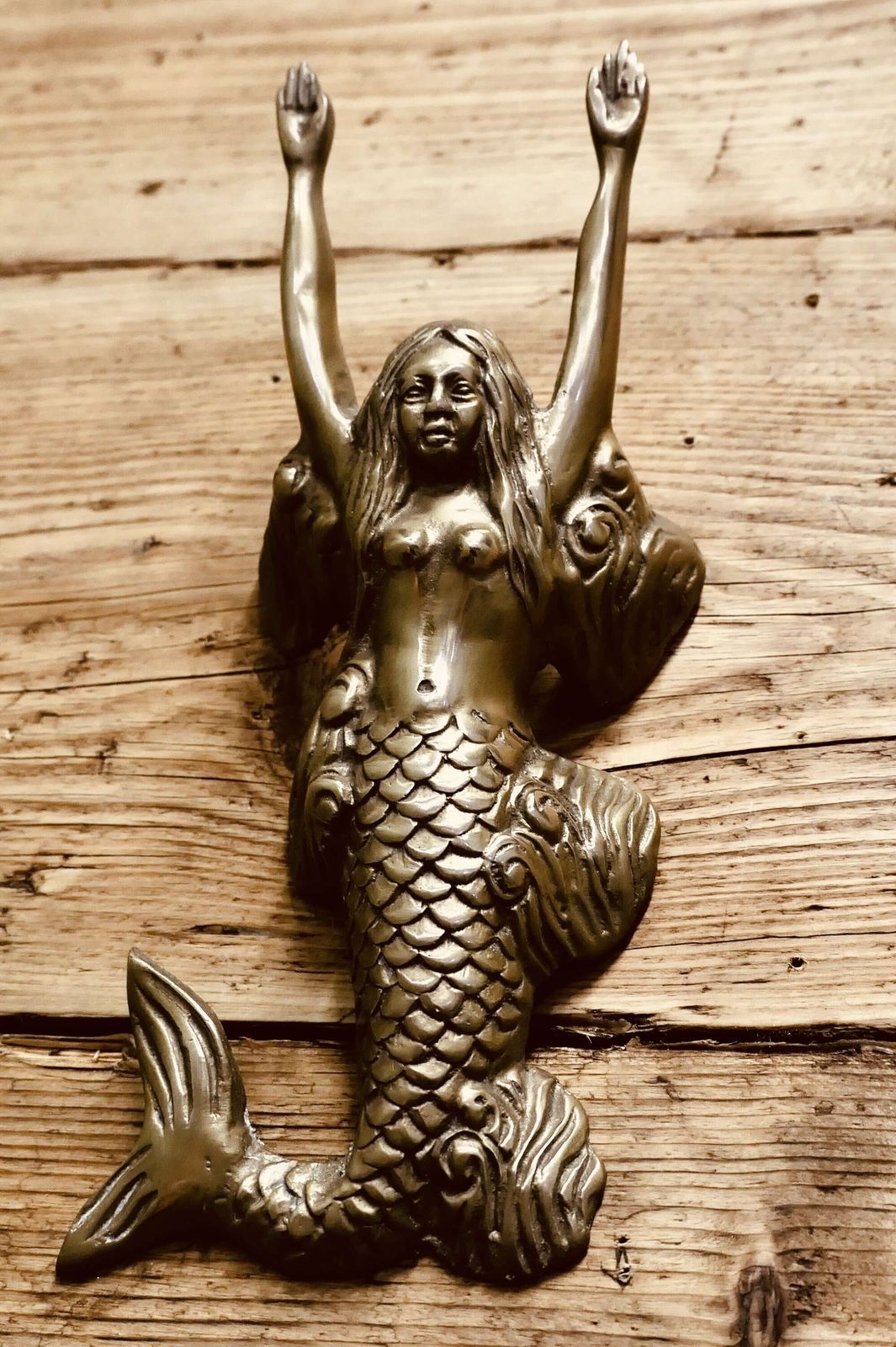 A Brass Door Knocker In The Shape Of A Mermaid photo vinterior