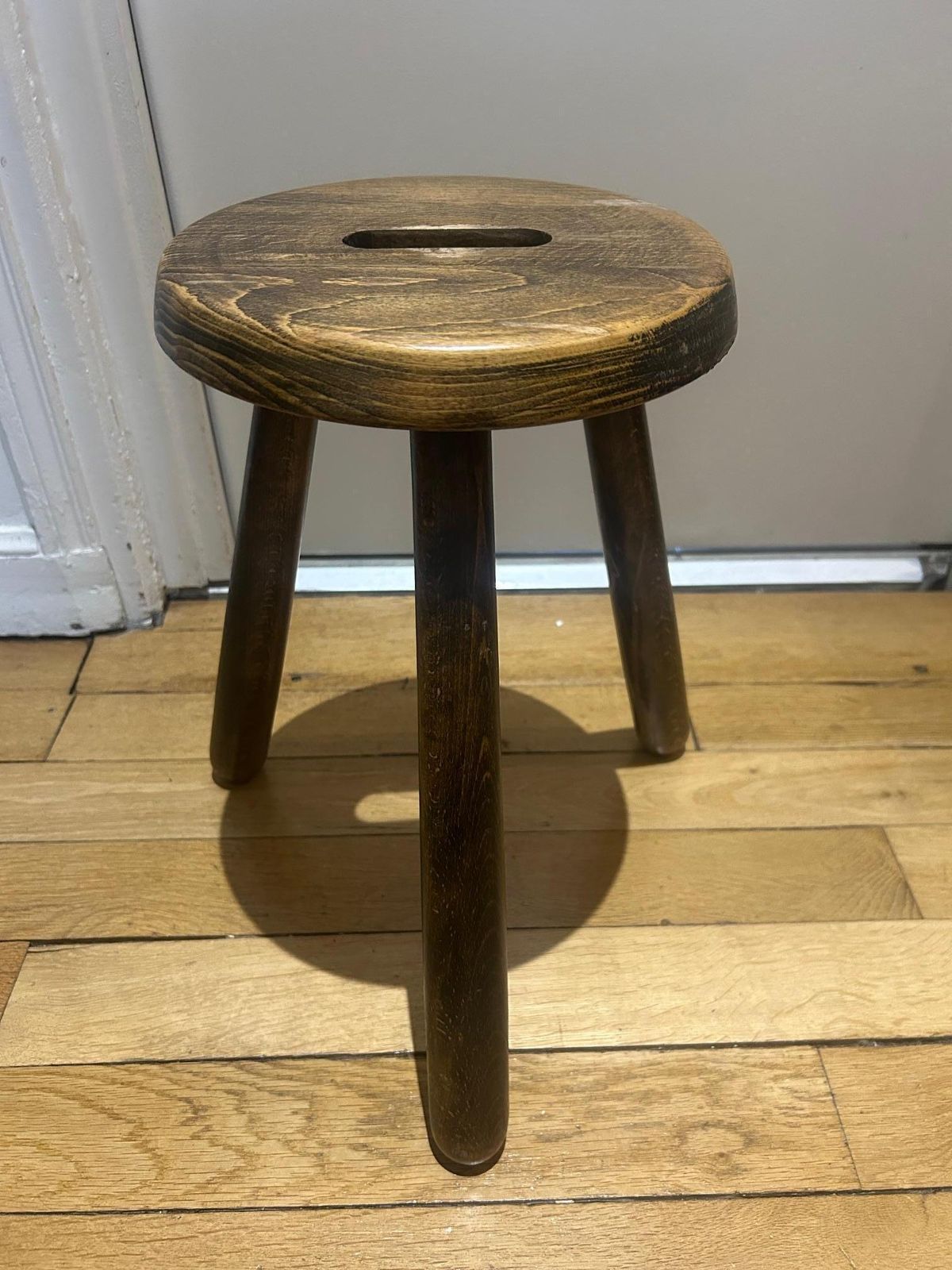 A Three Legged Wooden Stool With A Strong Brutalist photo 505.0