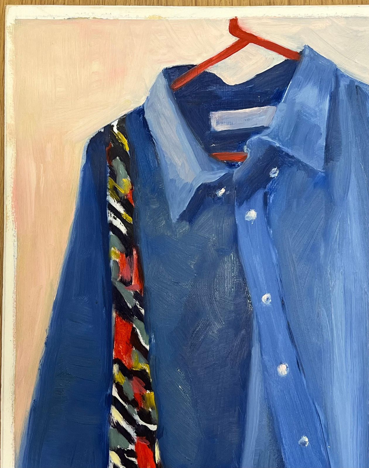 Jill Jacksonblue Denim Shirt Hanging On A Red Hanger With A Boldly Patterned Scarf photo vinterior