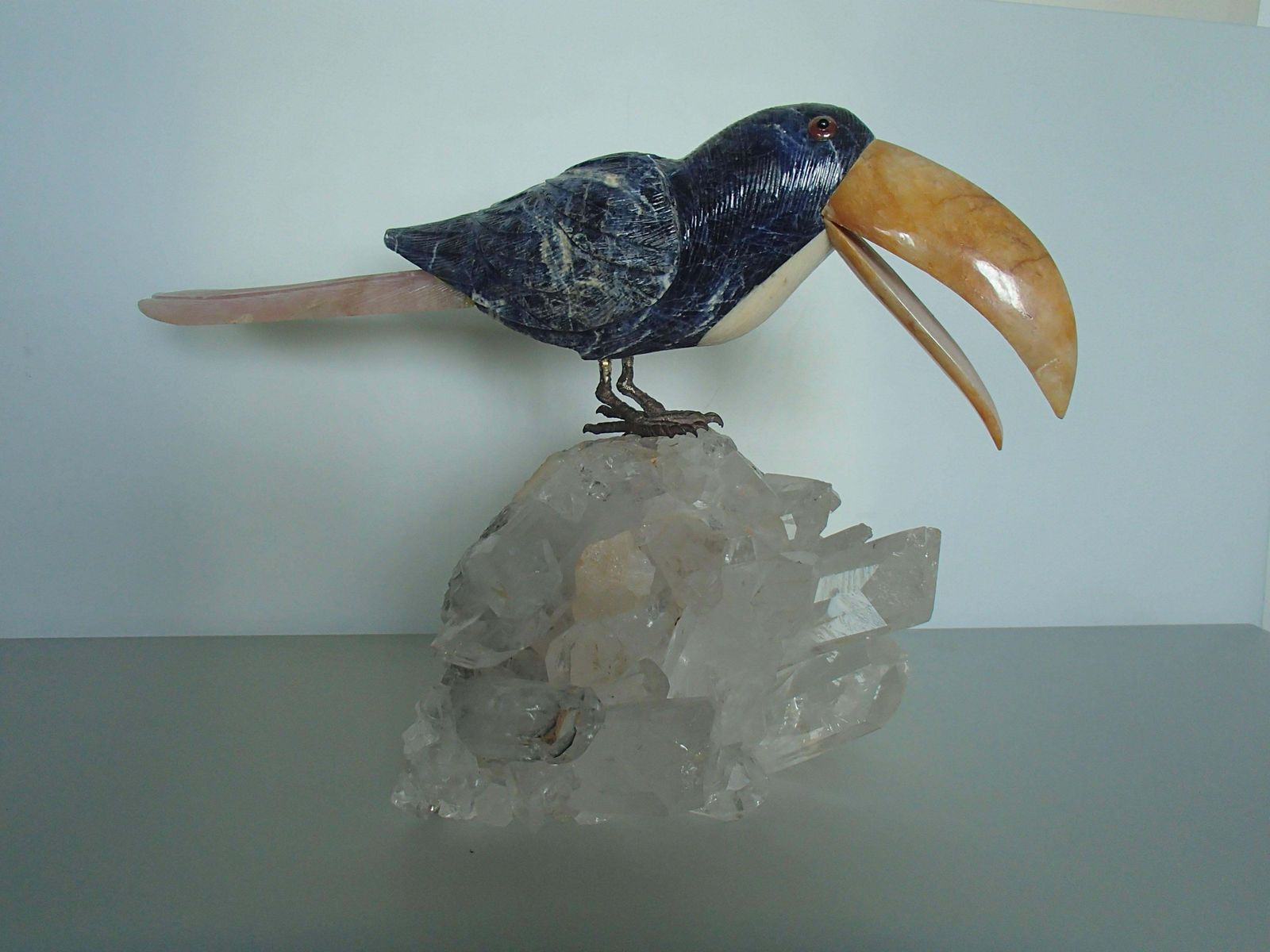 Tucan Sitting On A Cristall Made Of Sodalith And Rose Quarz photo furniture
