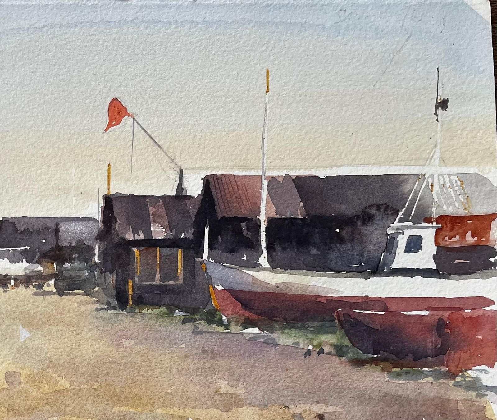 Anthony Herbert Coastal Boatyard With Fishing Huts Beached Boats And Red Flag Watercolour Scene photo for sale