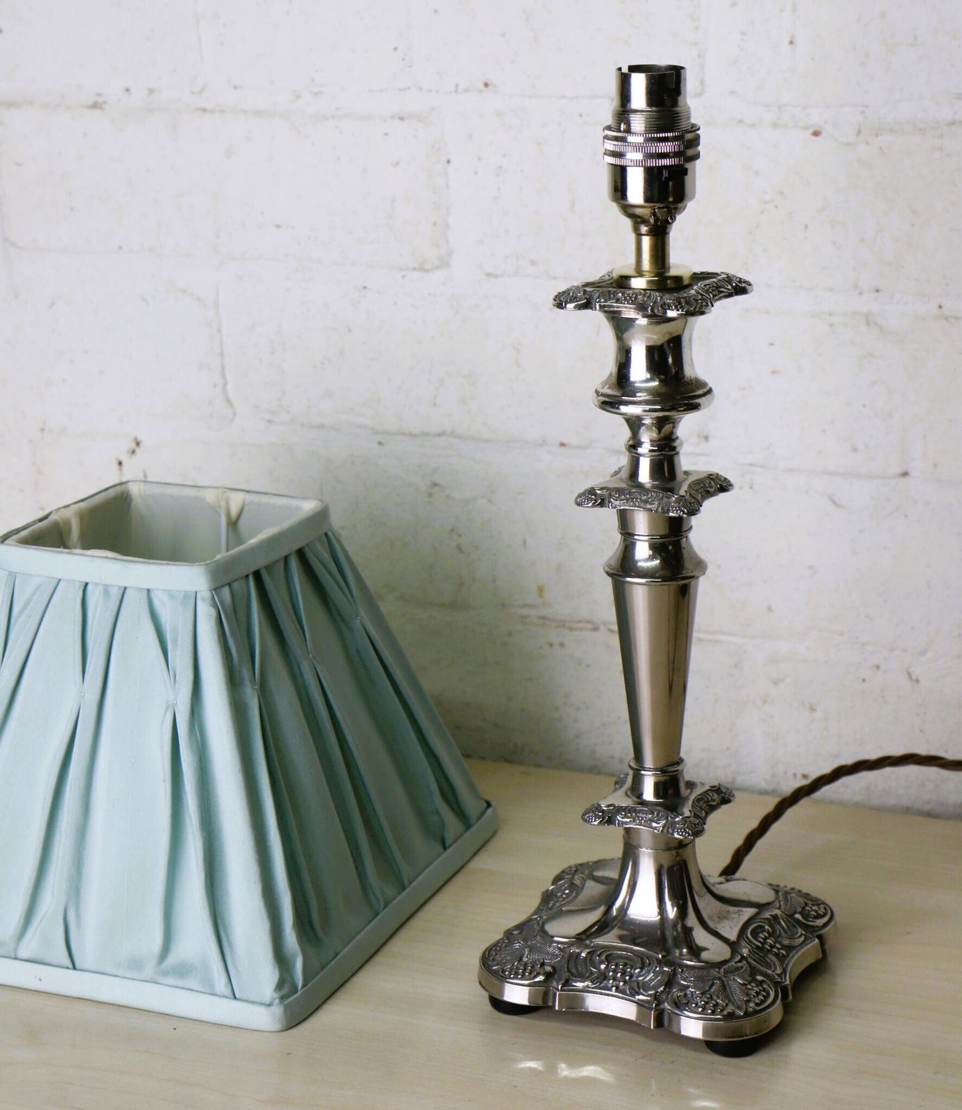 A Vintage Silver Plated Table Lamp With Ornate Castings With A Pale Sage Pinch Pleated Lampshade photo furniture