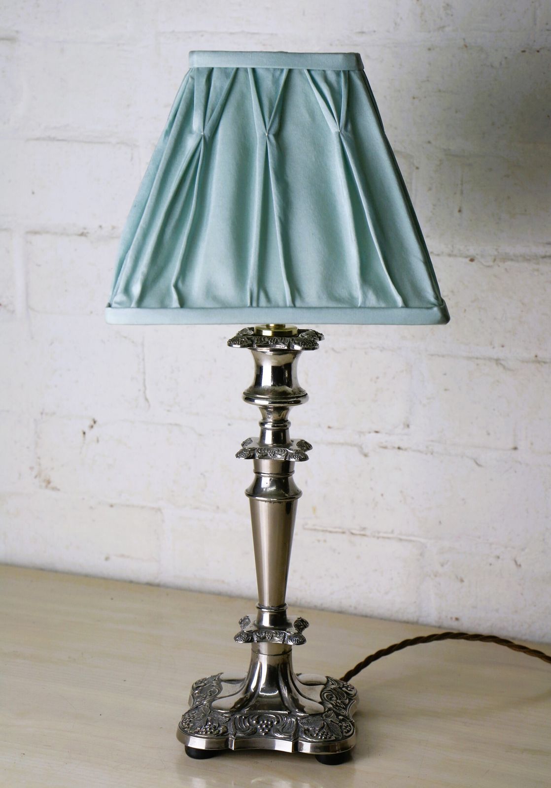 Lighting A Vintage Silver Plated Table Lamp With Ornate Castings With A Pale Sage Pinch Pleated Lampshade photo
