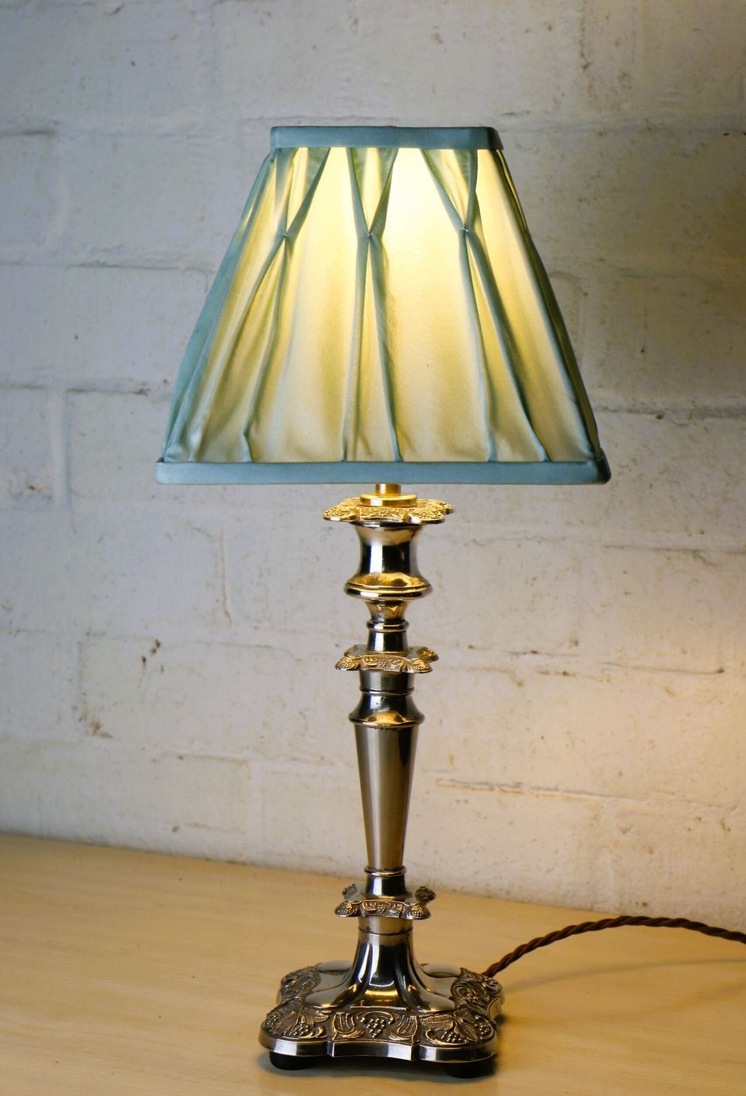 A Vintage Silver Plated Table Lamp With Ornate Castings With A Pale Sage Pinch Pleated Lampshade