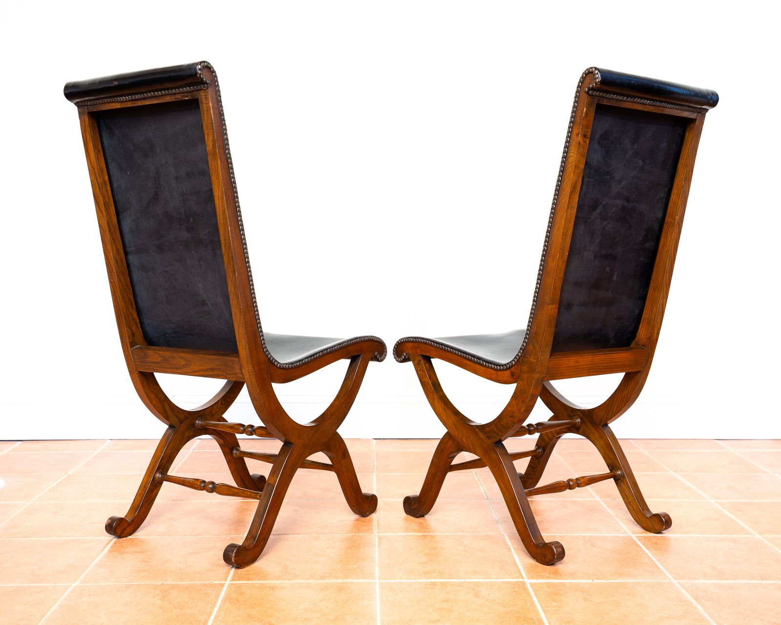 Pair Of Spanish Oak Leather Dining Chairs By Pierre Lottier Valmazan Mid Century Neoclassical Colonial 1960s Black Leather Sling Seat Studded Leather photo vinterior