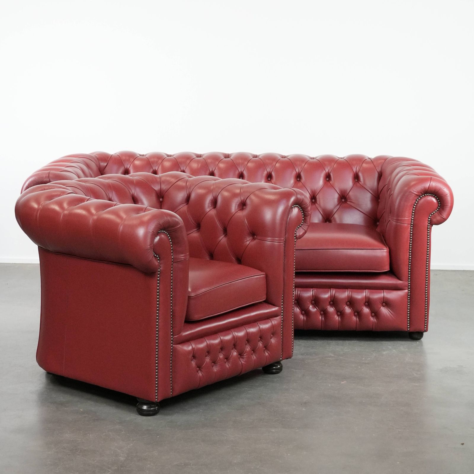 Wonderful Set Consisting Of An English Cowhide Chesterfield 2.5 Seater Sofa And Matching Armchair In A Stunning Red Colour