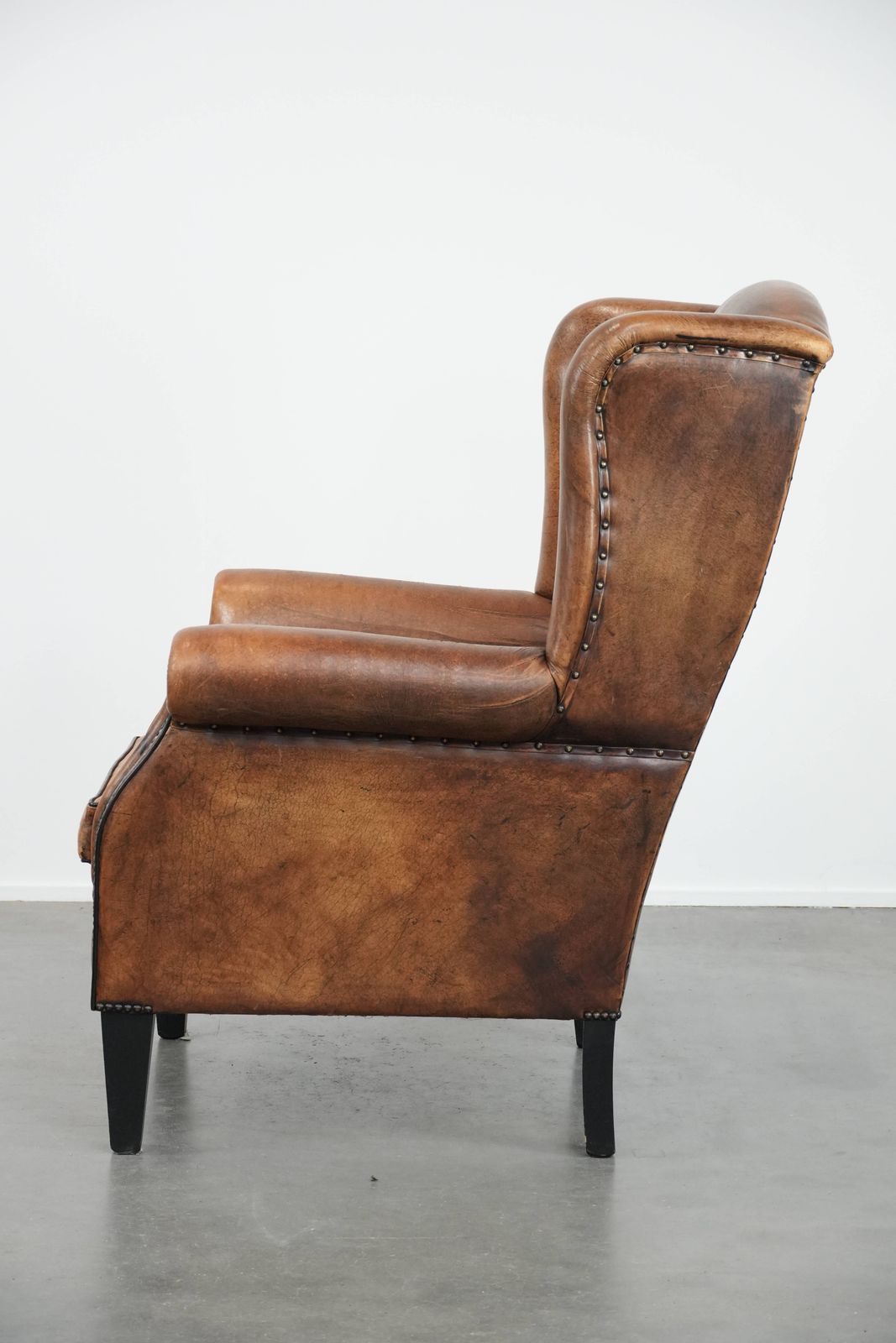 Large And Comfortable Sheepskin Wing Chair With A Characterful Look With Black Piping And Decorative Studs photo 896.0