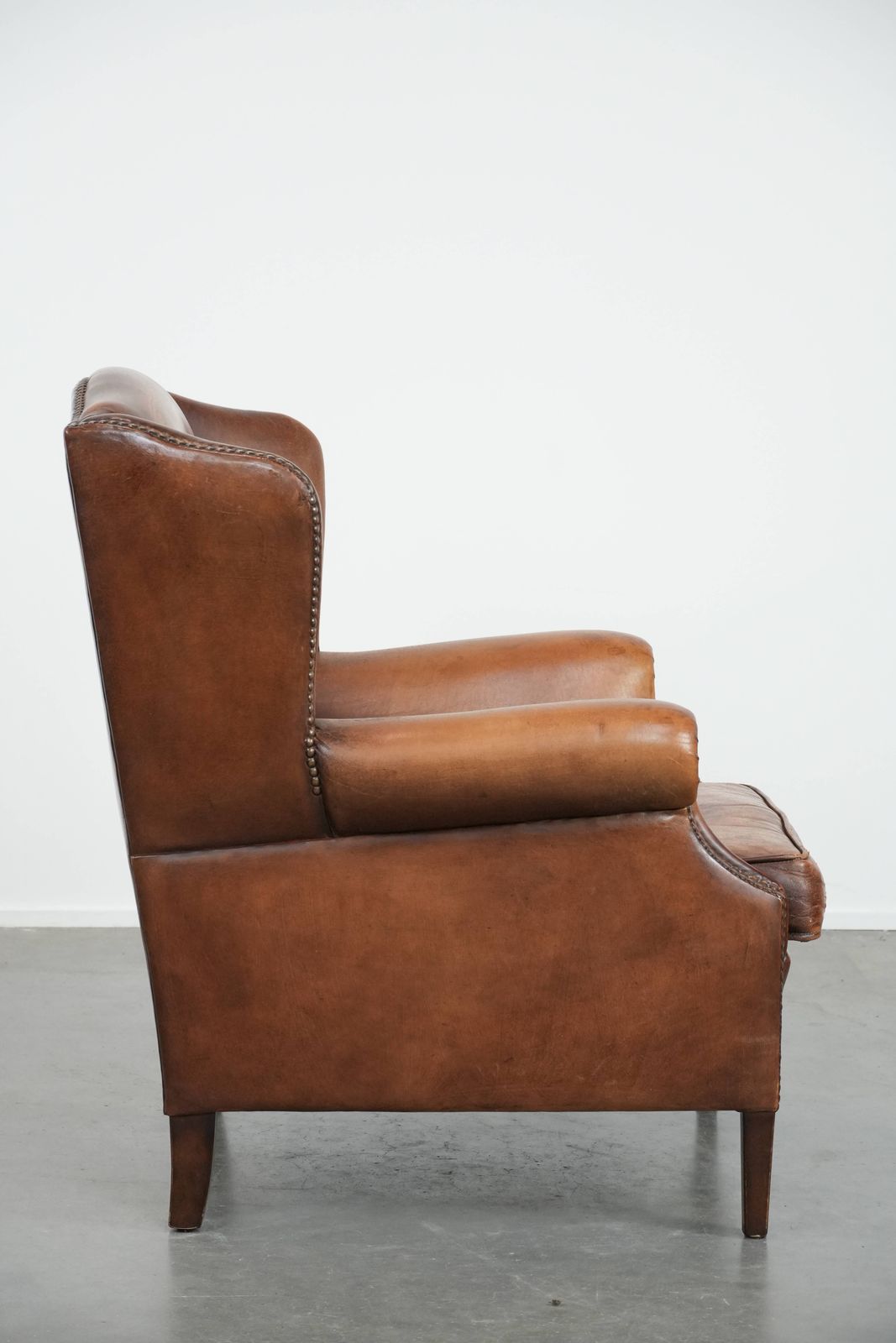 Charming Sheepskin Wing Chair With Warm Colours Finished With Decorative Studs photo for sale