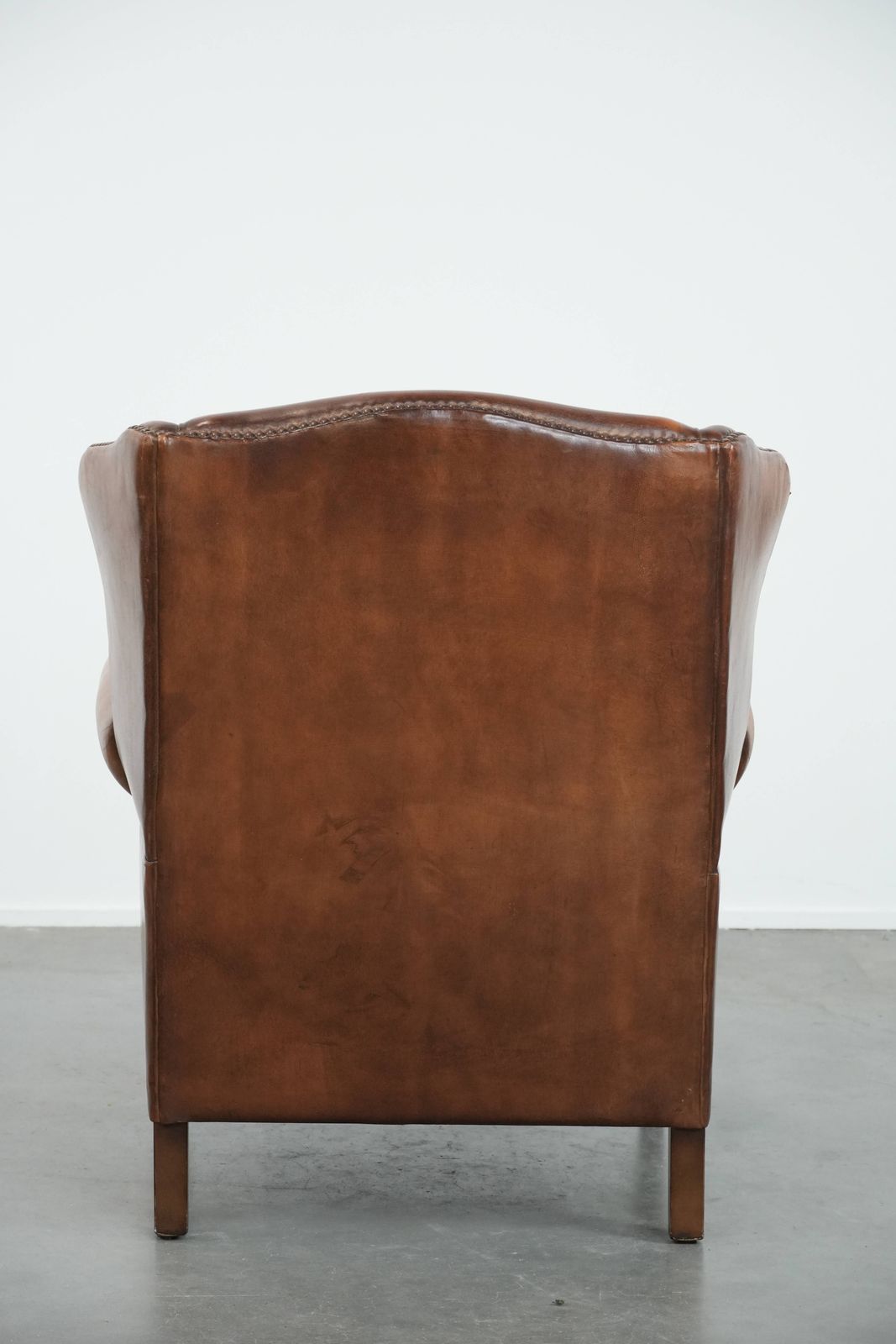 Charming Sheepskin Wing Chair With Warm Colours Finished With Decorative Studs photo Furniture
