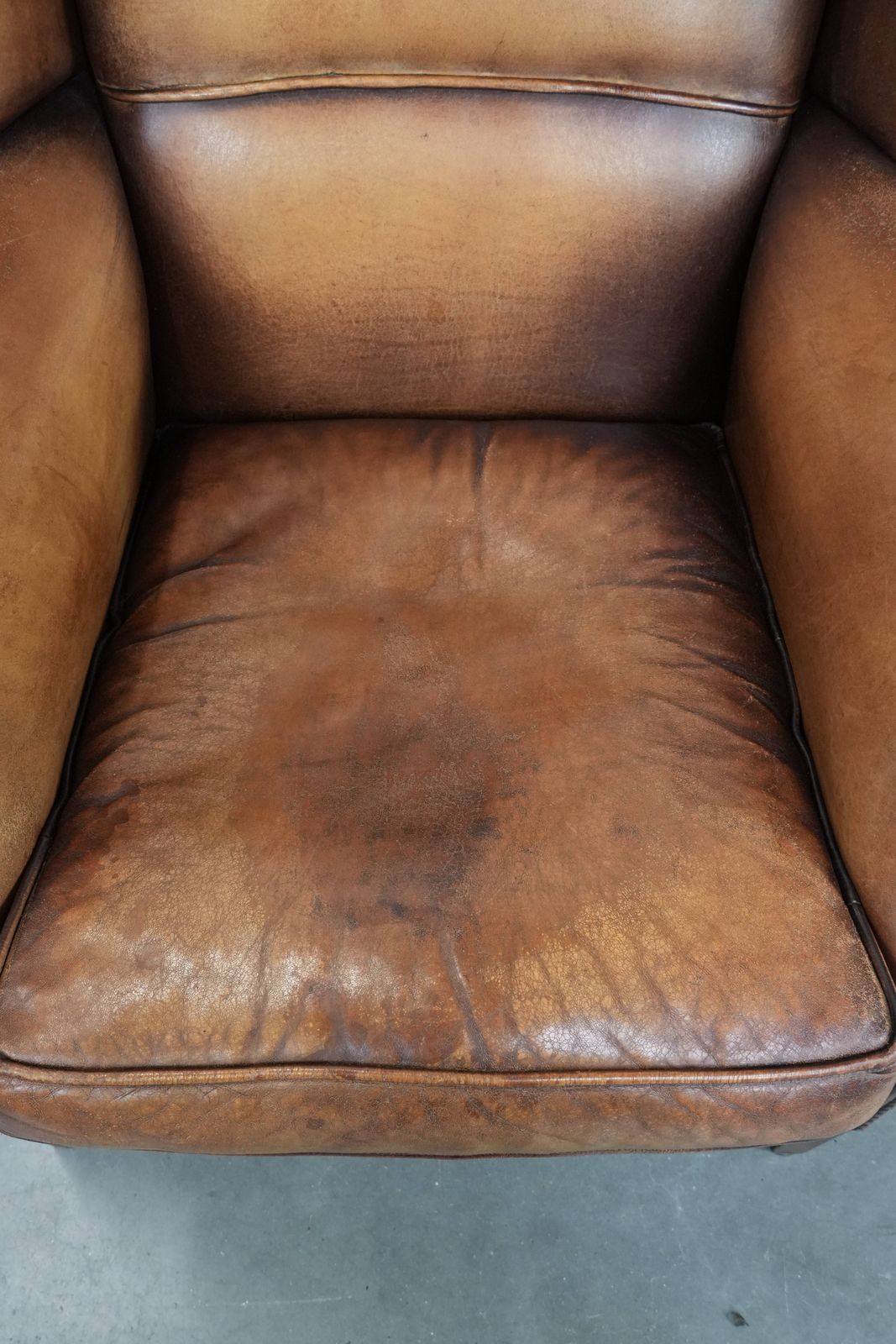 Charming Sheepskin Wing Chair With Warm Colours Finished With Decorative Studs photo vinterior