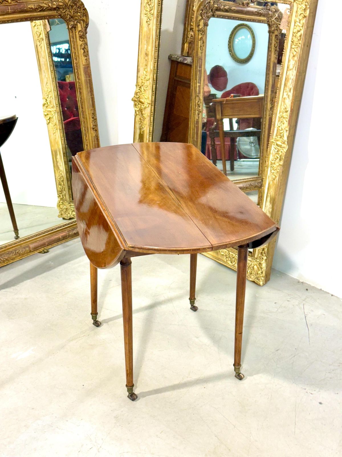 photo furniture Early 19th Century French Cherrywood Drop Leaf Table On Gilt Bronze Casters
