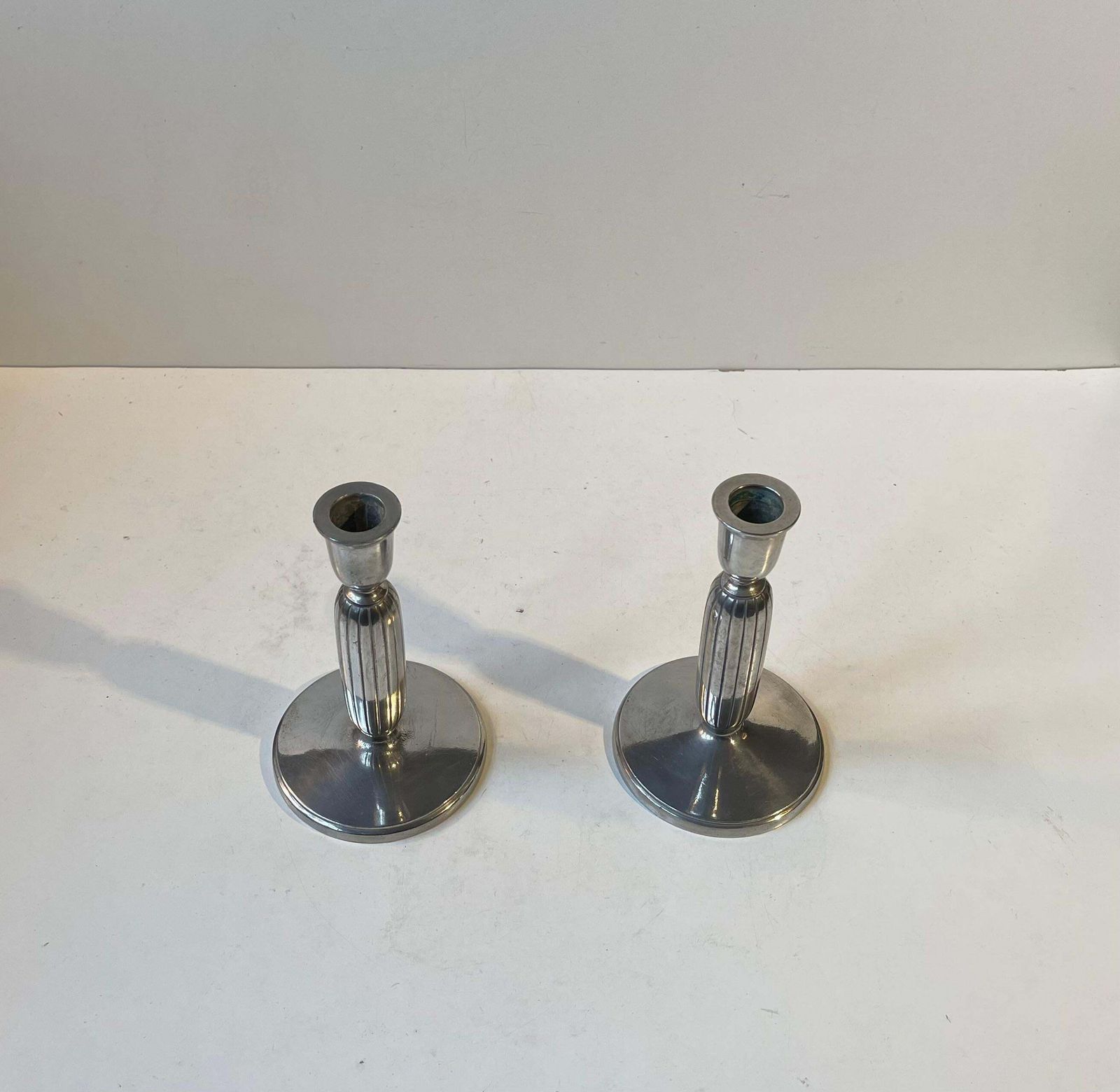 Just Andersen   A Pair Of Art Deco Column Candlesticks In Pewter, 1930s photo furniture