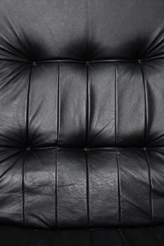 photo for sale Set Of Mid Century Modern Danish Black Leather Swivel Chair & Ottoman From Unico, 1970s