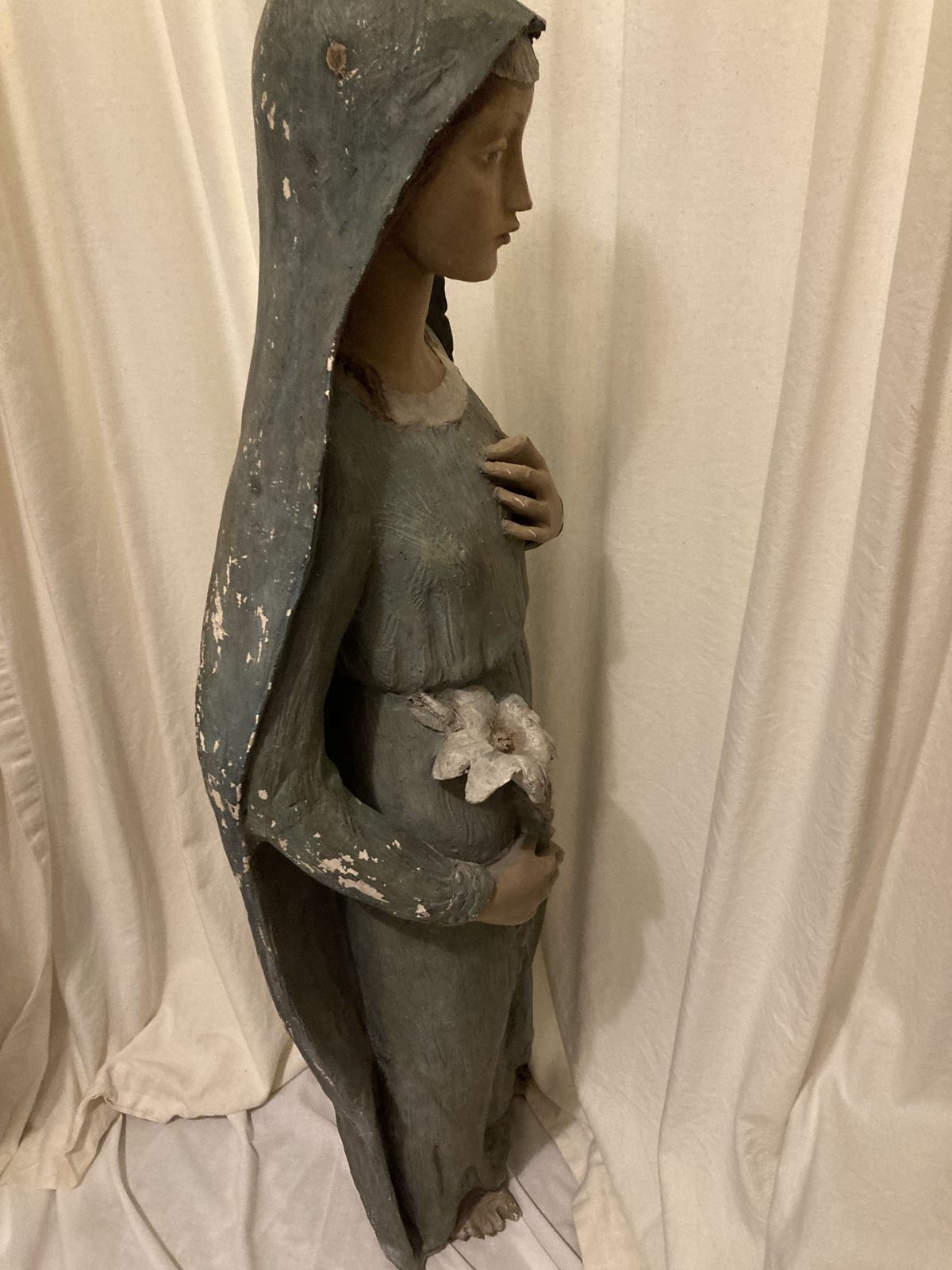Antique Statue Of The Young Virgin Mary Holding A Lily. photo 200.0