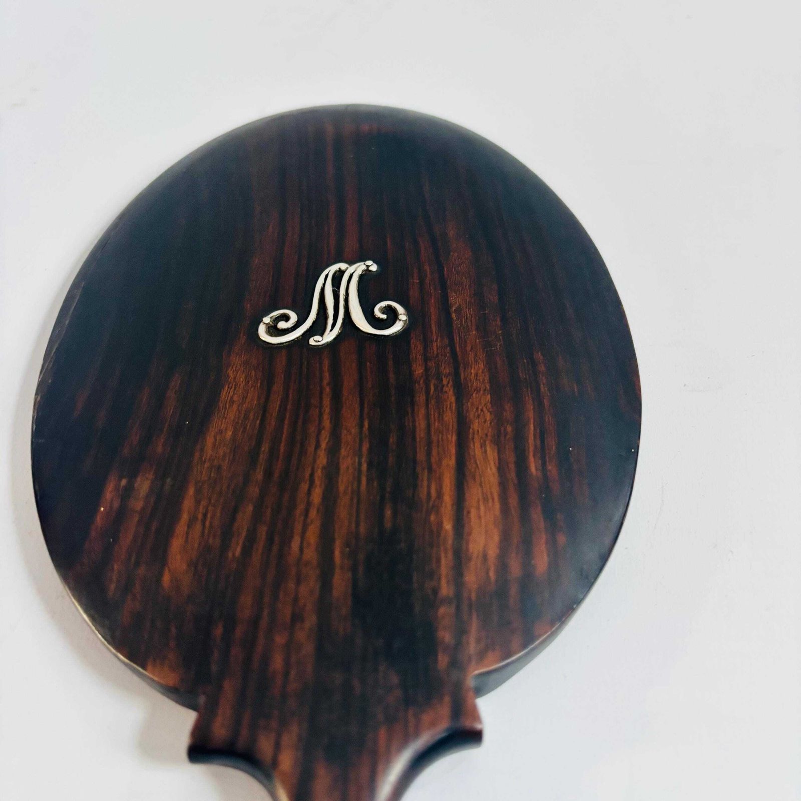 78.0 Antique Ebonised Beech Wood Hand Mirror: 1890s 'M' Silver Initial Victorian Bevelled Glass photo