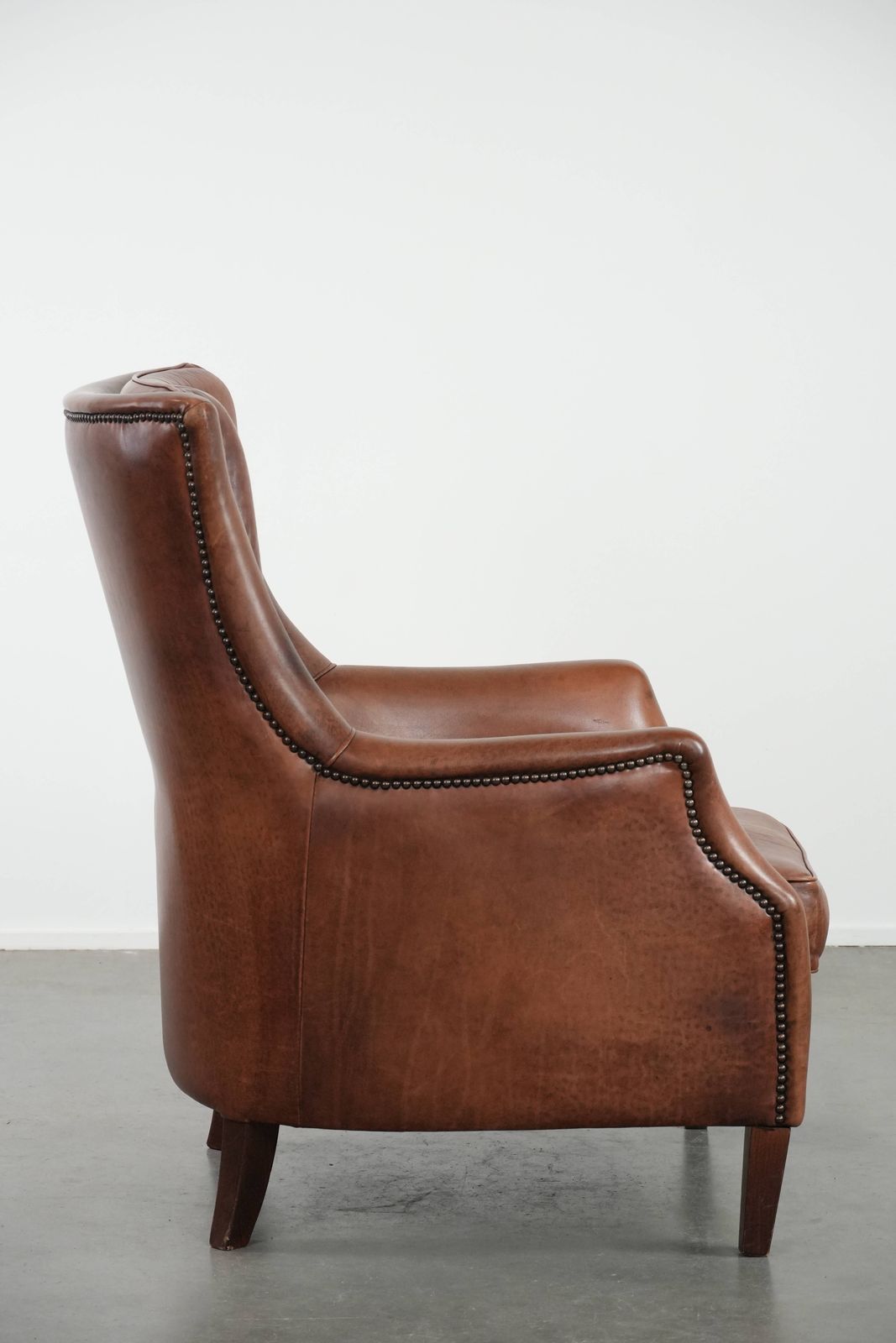 Very Comfortable And Luxurious Cognac Brown Cowhide Armchair With A Decorative Stud Finish photo for sale