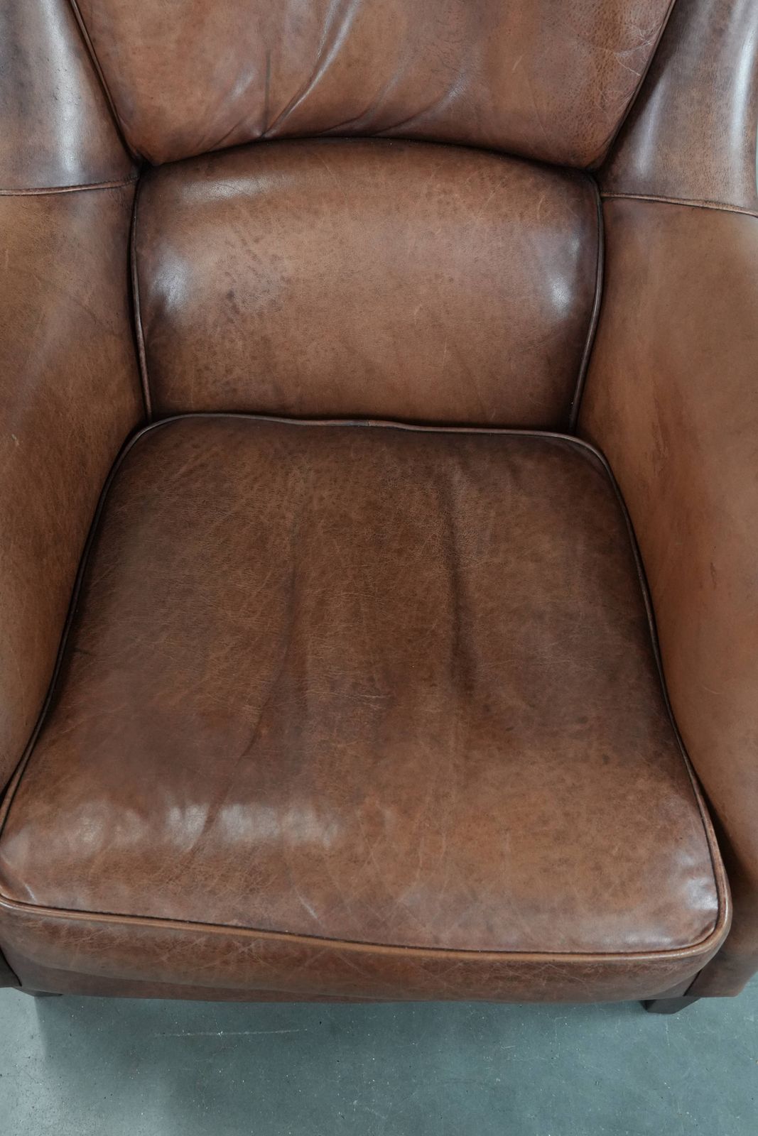 Very Comfortable And Luxurious Cognac Brown Cowhide Armchair With A Decorative Stud Finish photo vinterior
