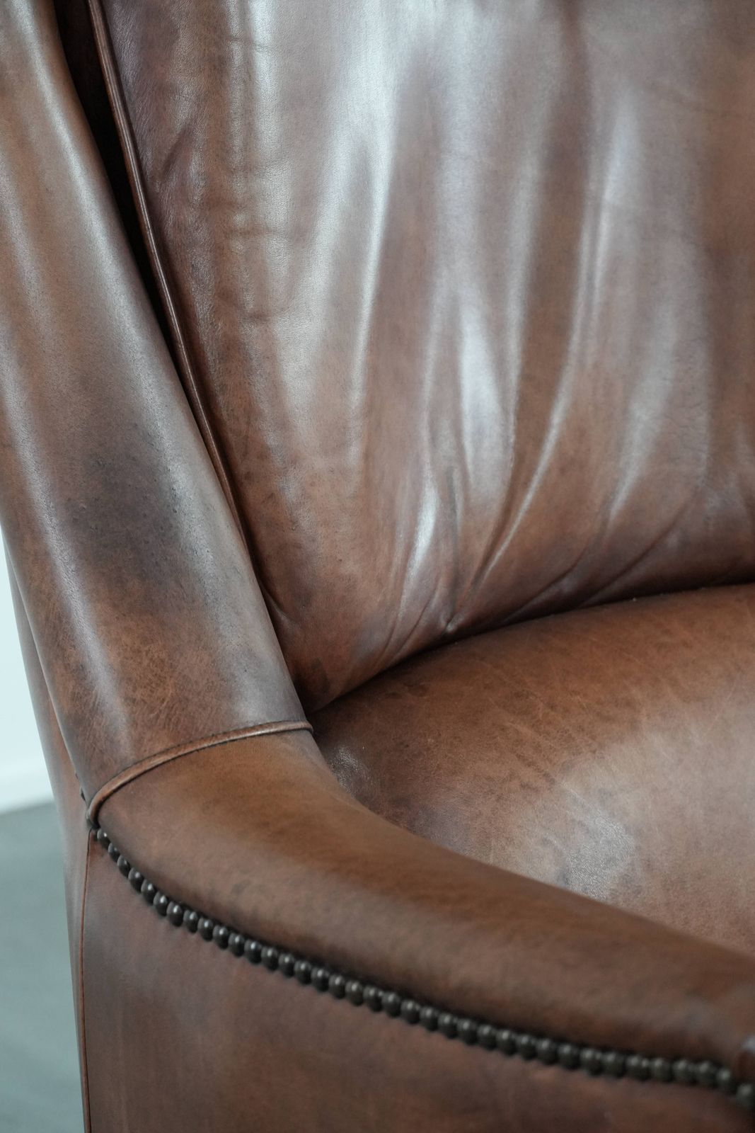 923.0 Very Comfortable And Luxurious Cognac Brown Cowhide Armchair With A Decorative Stud Finish photo