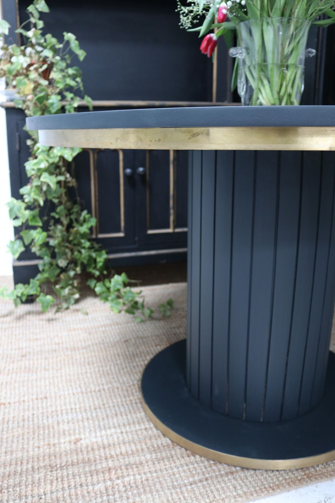 Stunning Black Round Dining Table With Brass Metal Edge Slatted Wood Column Base photo vinterior