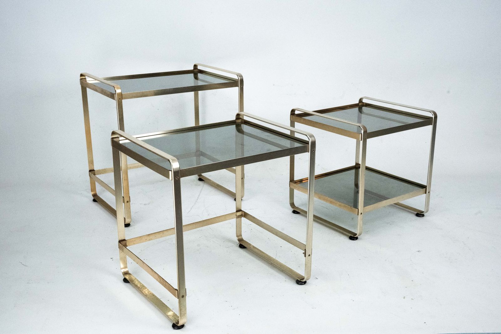 Set Of Three Nesting Side Tables In Gilded Aluminum And Glass – Italy, 1970s photo for sale
