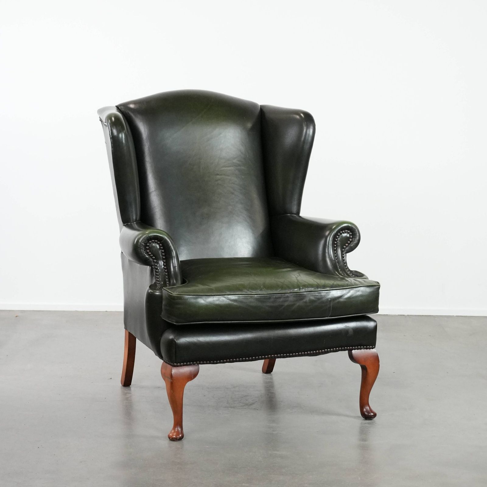 Beautiful Smooth Classic Cowhide Chesterfield Wing Chair In A Stylish Dark Green Color