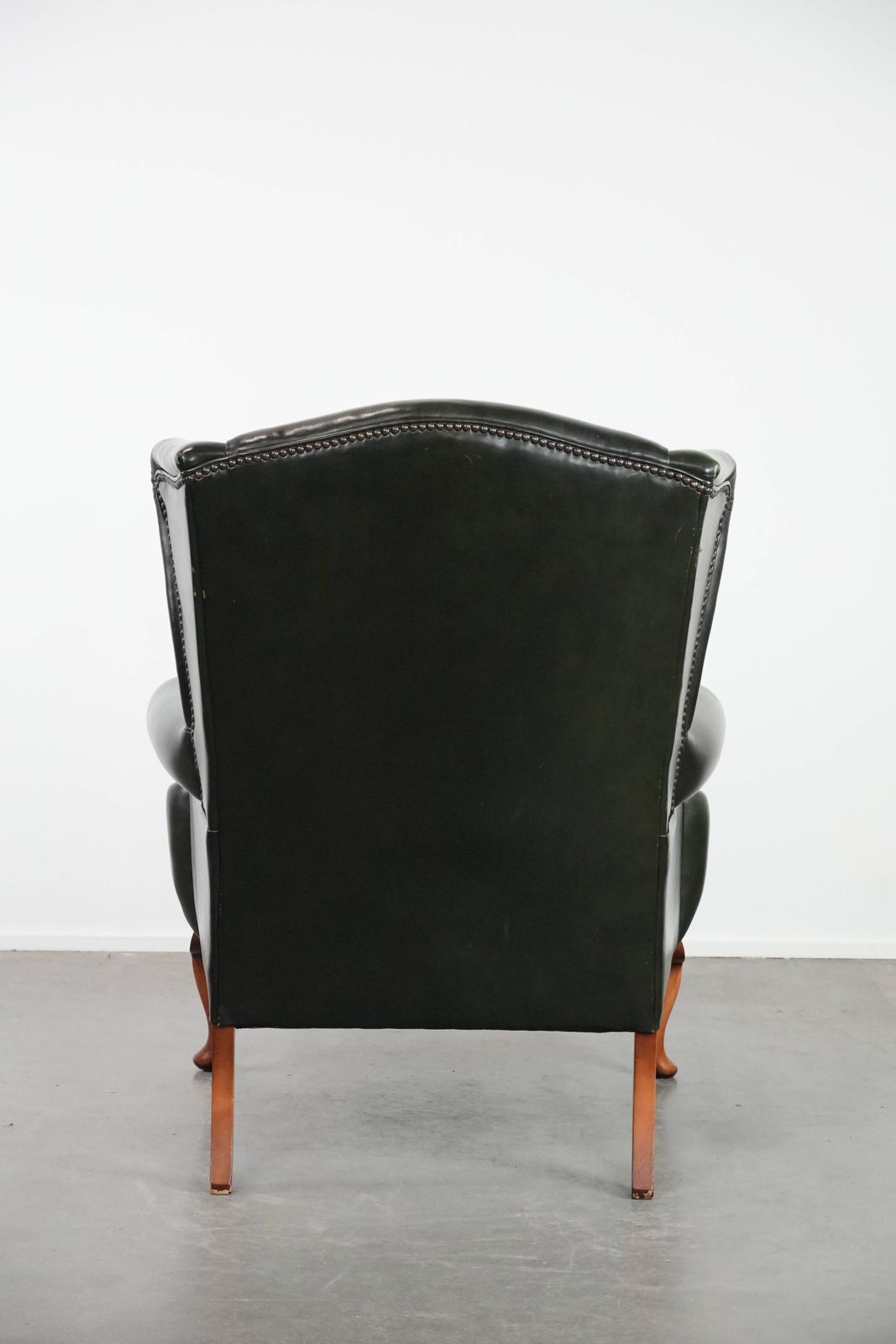 Beautiful Smooth Classic Cowhide Chesterfield Wing Chair In A Stylish Dark Green Color photo Furniture