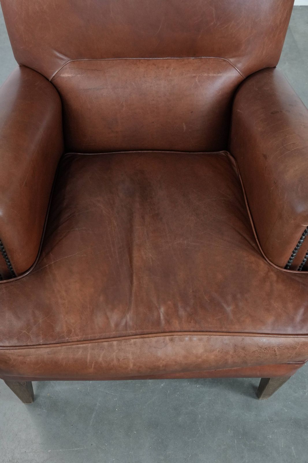 Nice And Comfortable Armchair Made Of Cognac Colored Cowhide In English Style photo vinterior