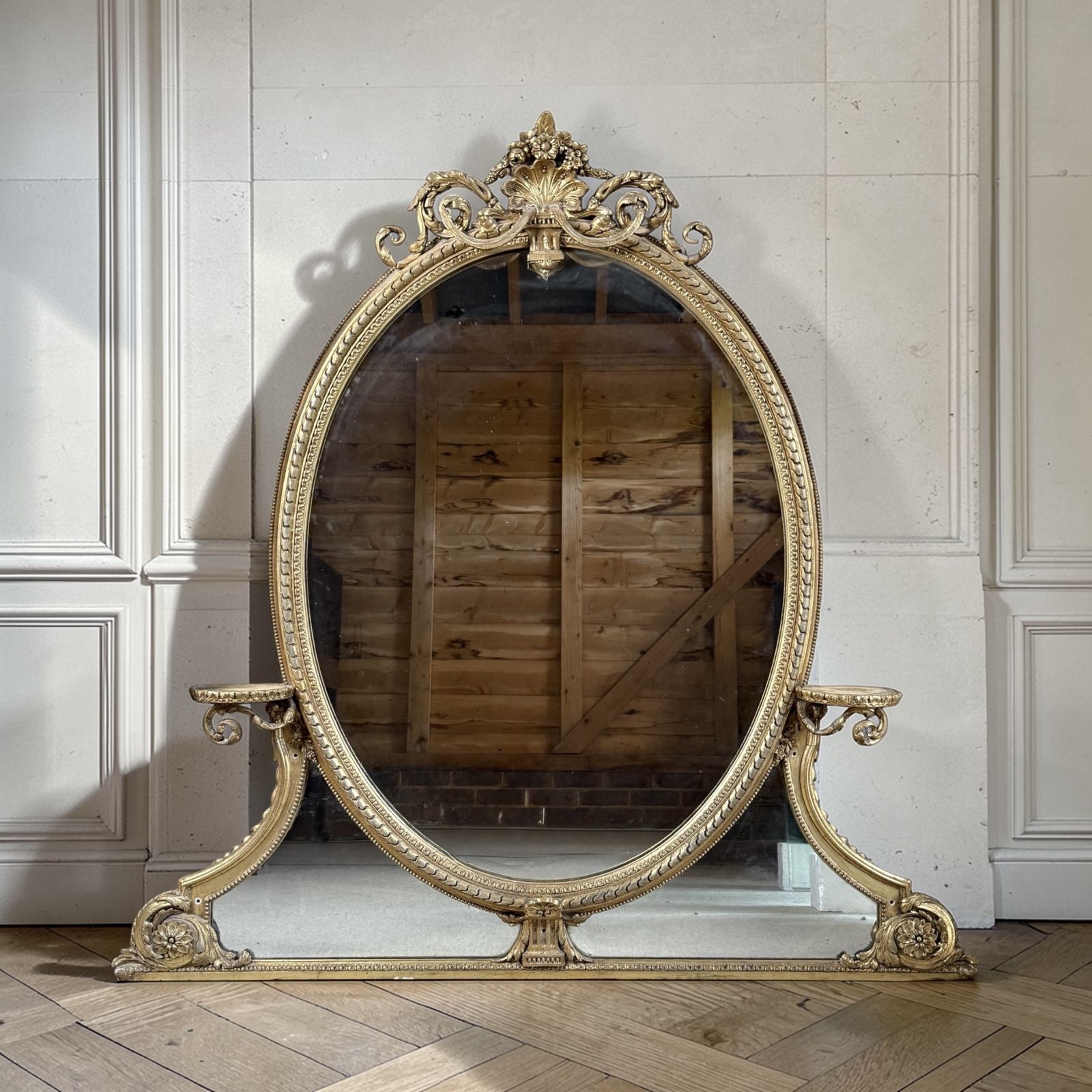 19th Century French Giltwood Oval Overmantel Mirror With Crest & Side Shelves