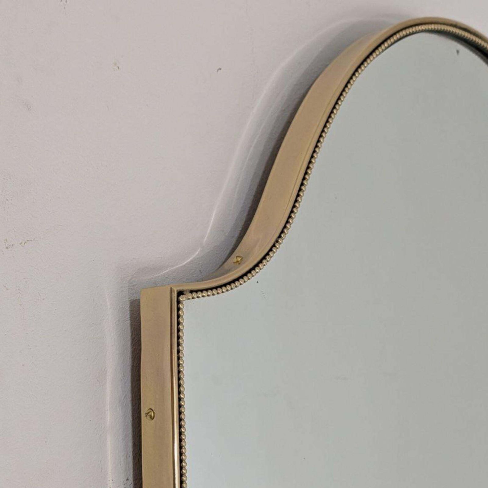 1950s Mid Century Modern Italian Brass Shield Shaped Mirror In The Style Of Gio photo for sale