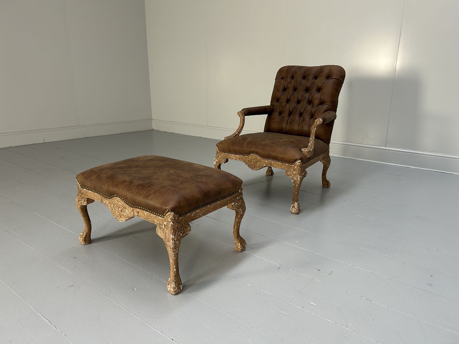 Andrew Martin Buttoned Back Armchair And Stool In Antiqued Brown Leather