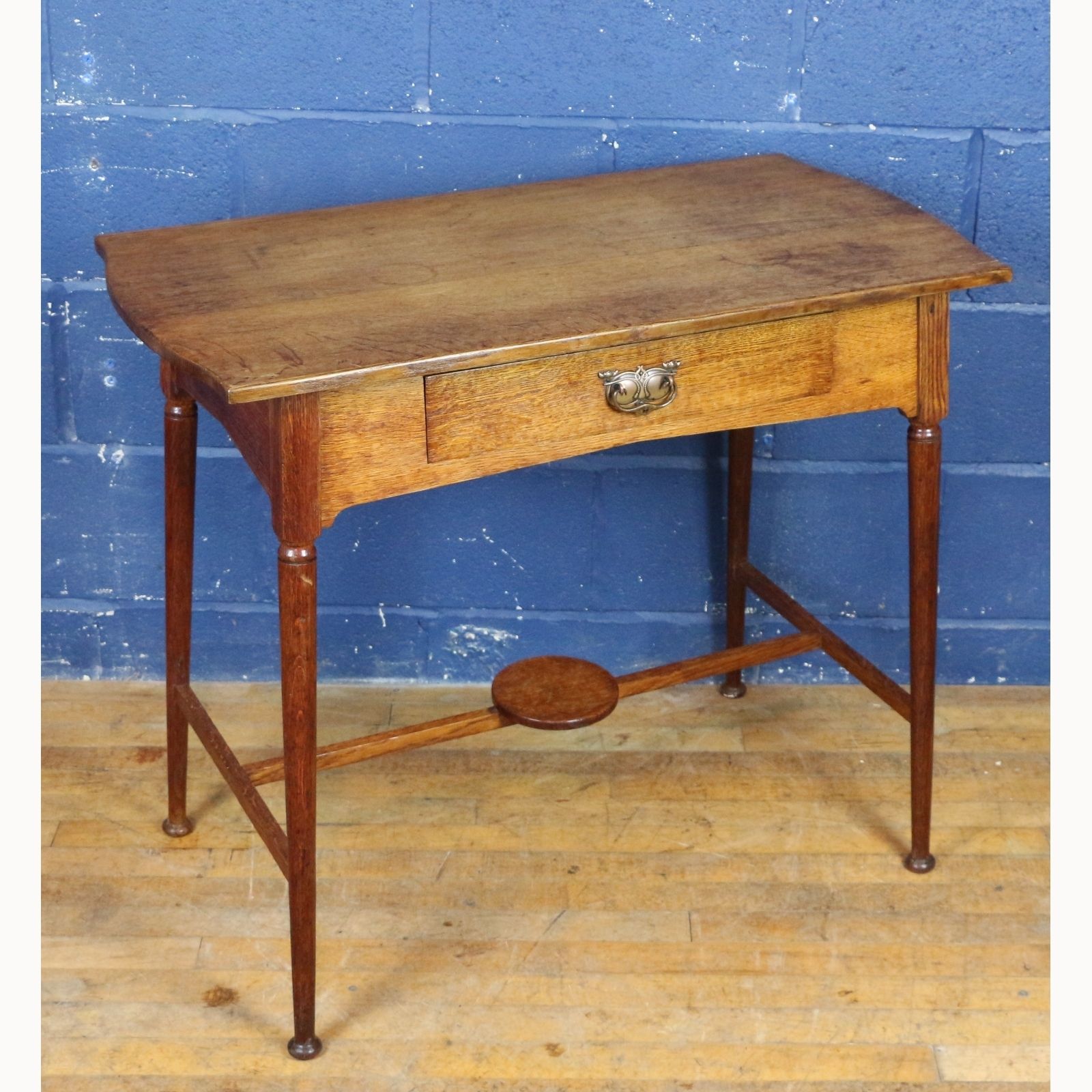 An Art Nouveau Oak Single Drawer Side Table Raised On Turned Angled Supports photo furniture