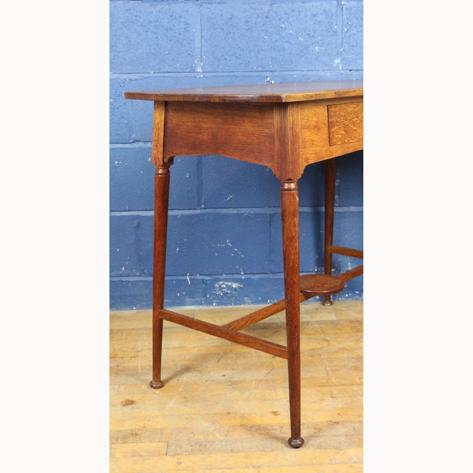 photo furniture An Art Nouveau Oak Single Drawer Side Table Raised On Turned Angled Supports