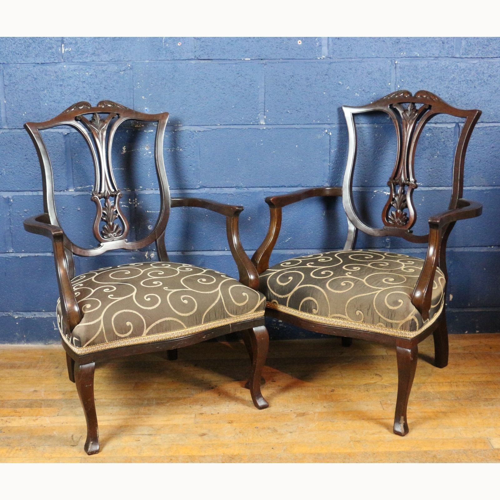 A Pair Of Victorian Carved Mahogany Open Arm Chairs Raised On Cabriole Legs