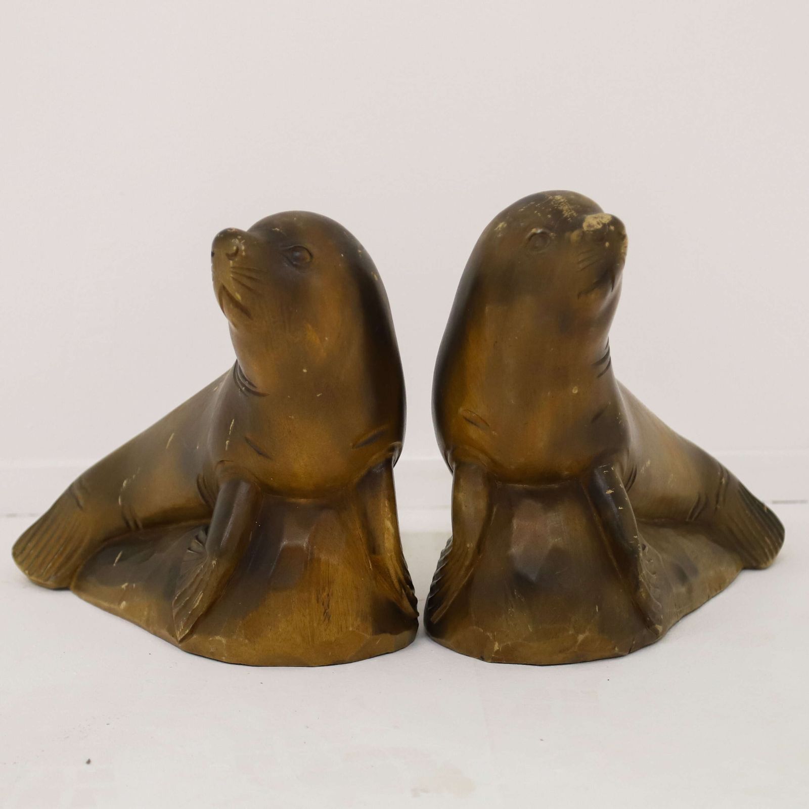 photo for sale Highly Decorative Pair Of Mid‑Century Seal Sculptures   1950s Carved Figures
