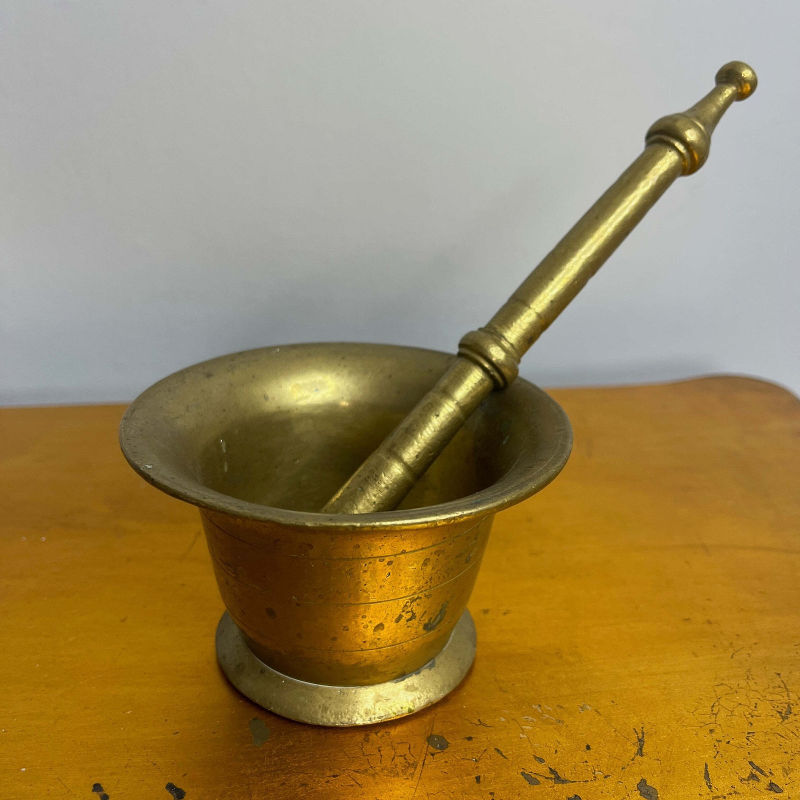 Antique Brass Mortar And Pestle On A Carved Wooden Wall Bracket photo furniture