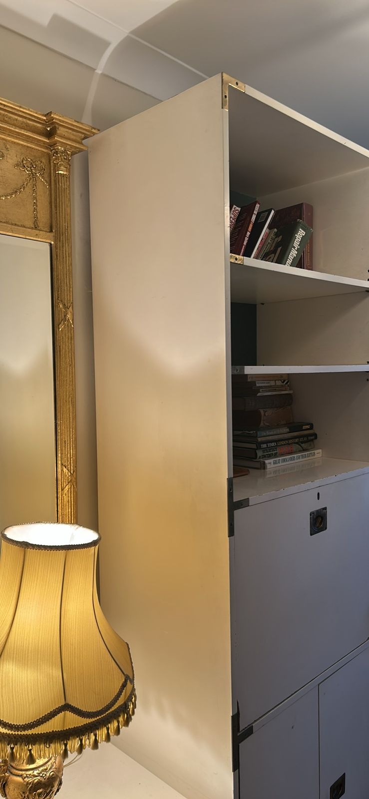 A Mid Century Modular White Shelving Unit In A Campaign Style With Solid Brass Features