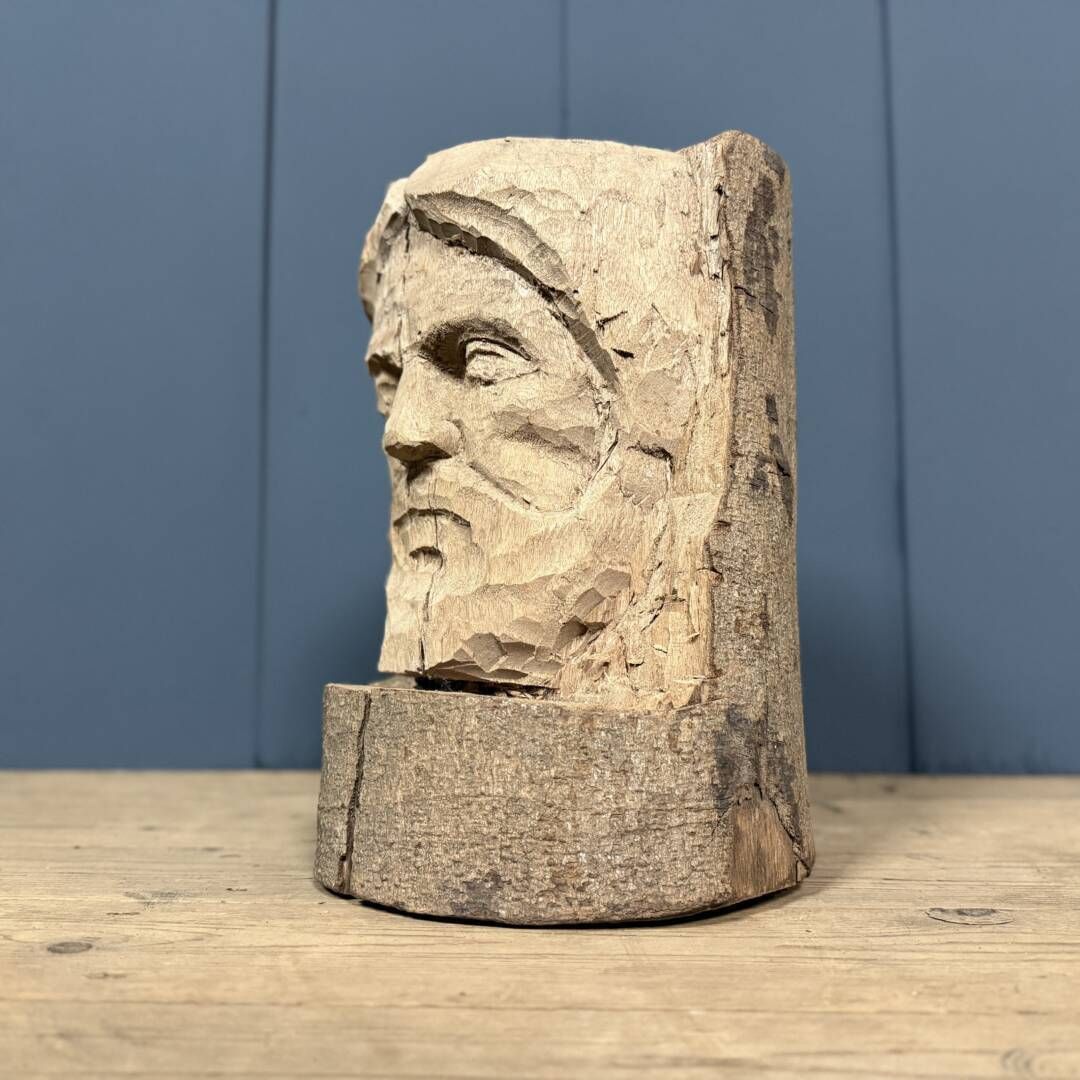 Head Of A Bearded Man Carved From A Wooden Trunk