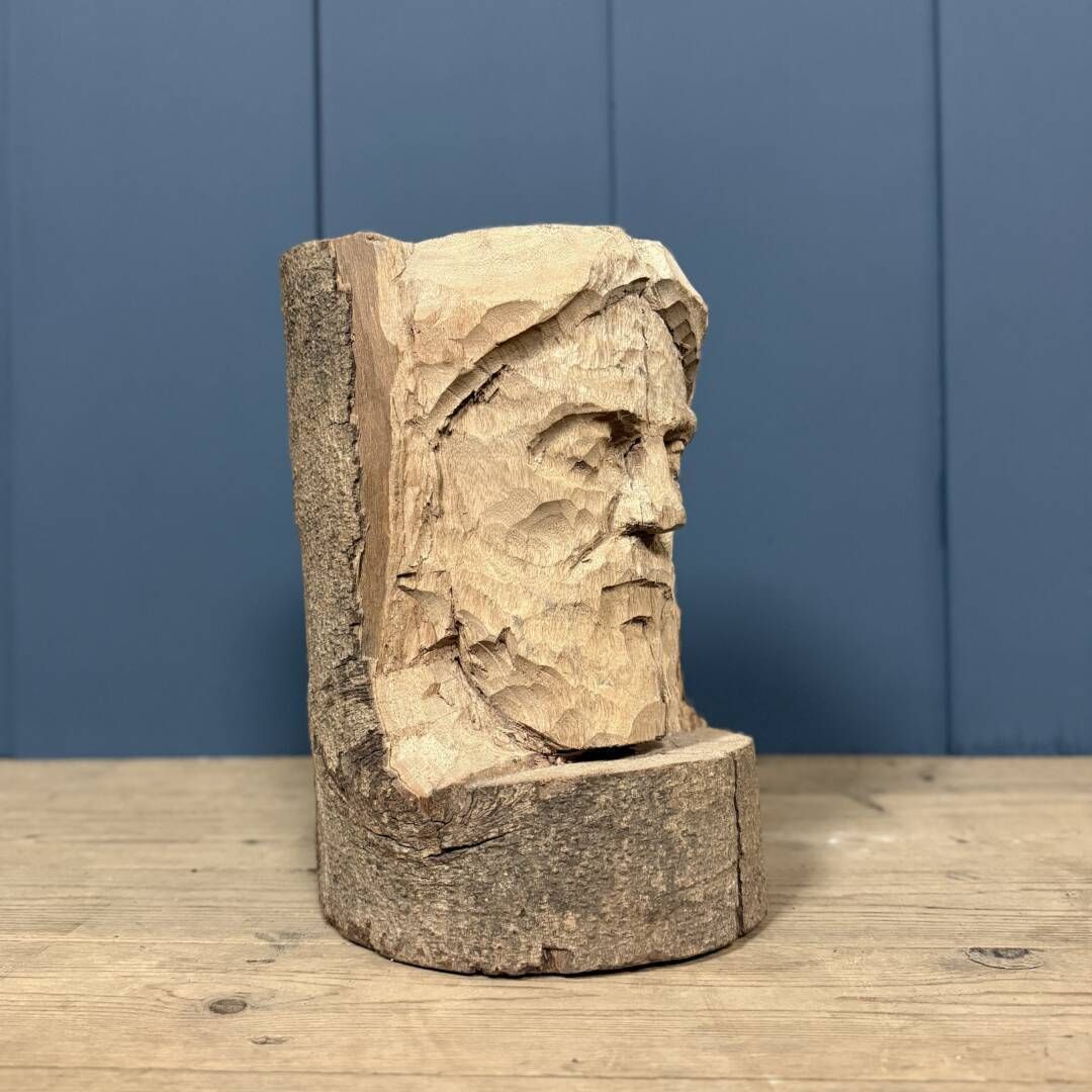 Head Of A Bearded Man Carved From A Wooden Trunk photo vintage
