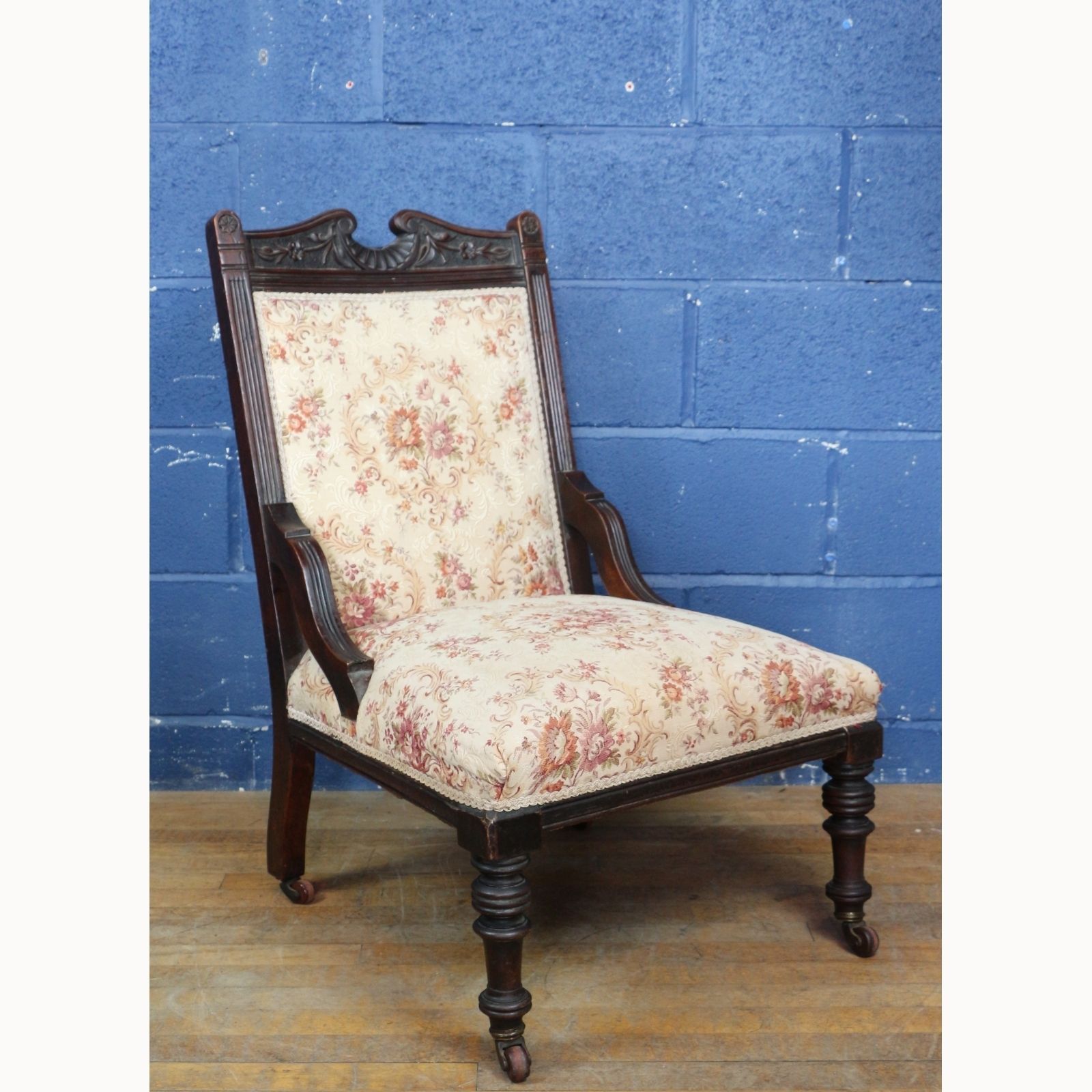 A Victorian Carved Walnut Framed Fireside Chair Raised On Turned Supports