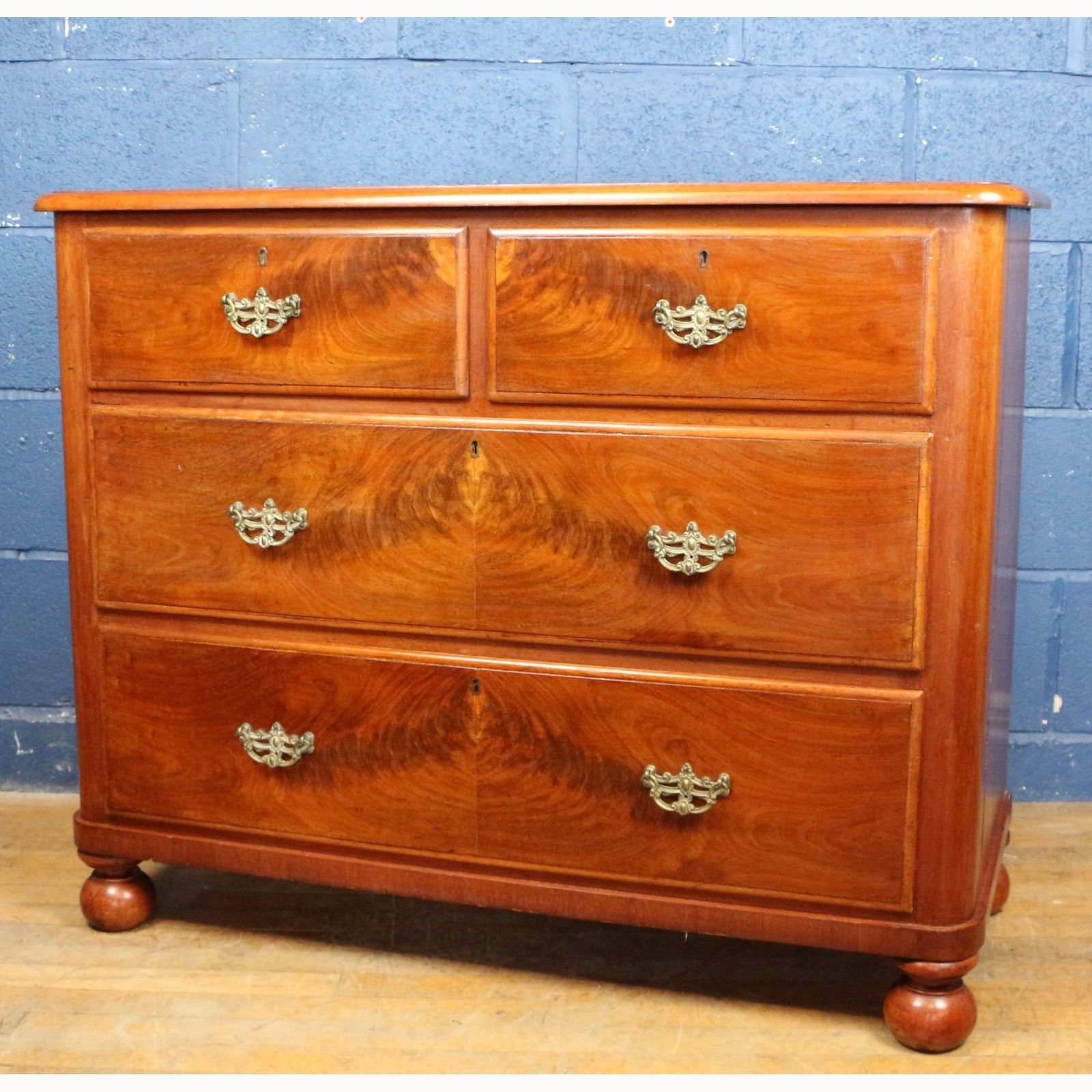 A Victorian Mahogany Two Over Two Chest Of Drawers Raised On Bun Feet