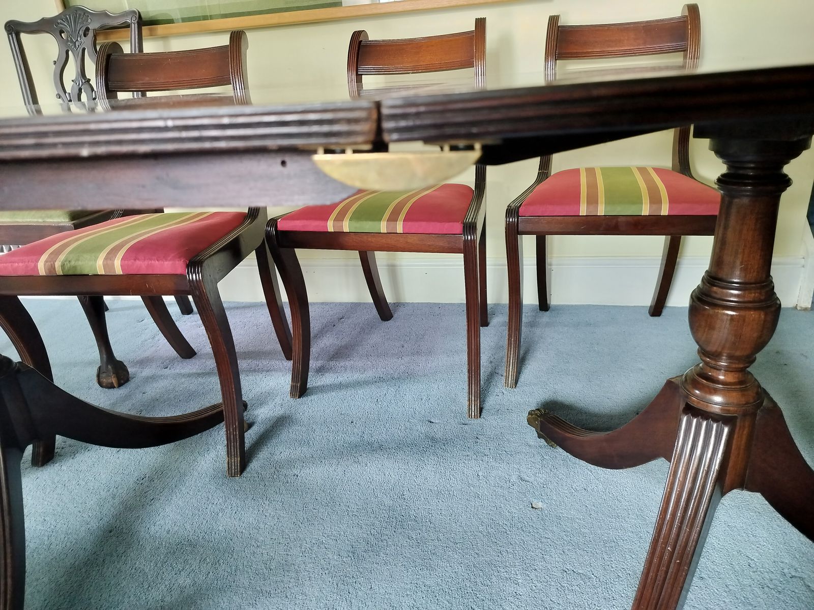 Regency Style Twin Pillar Dining Table With Removable Central Leaf.  Features Splayed Legs With Brass Castors Designed To Sit Up To 8 People.  Comes With 5 Chairs And 2 Carvers.