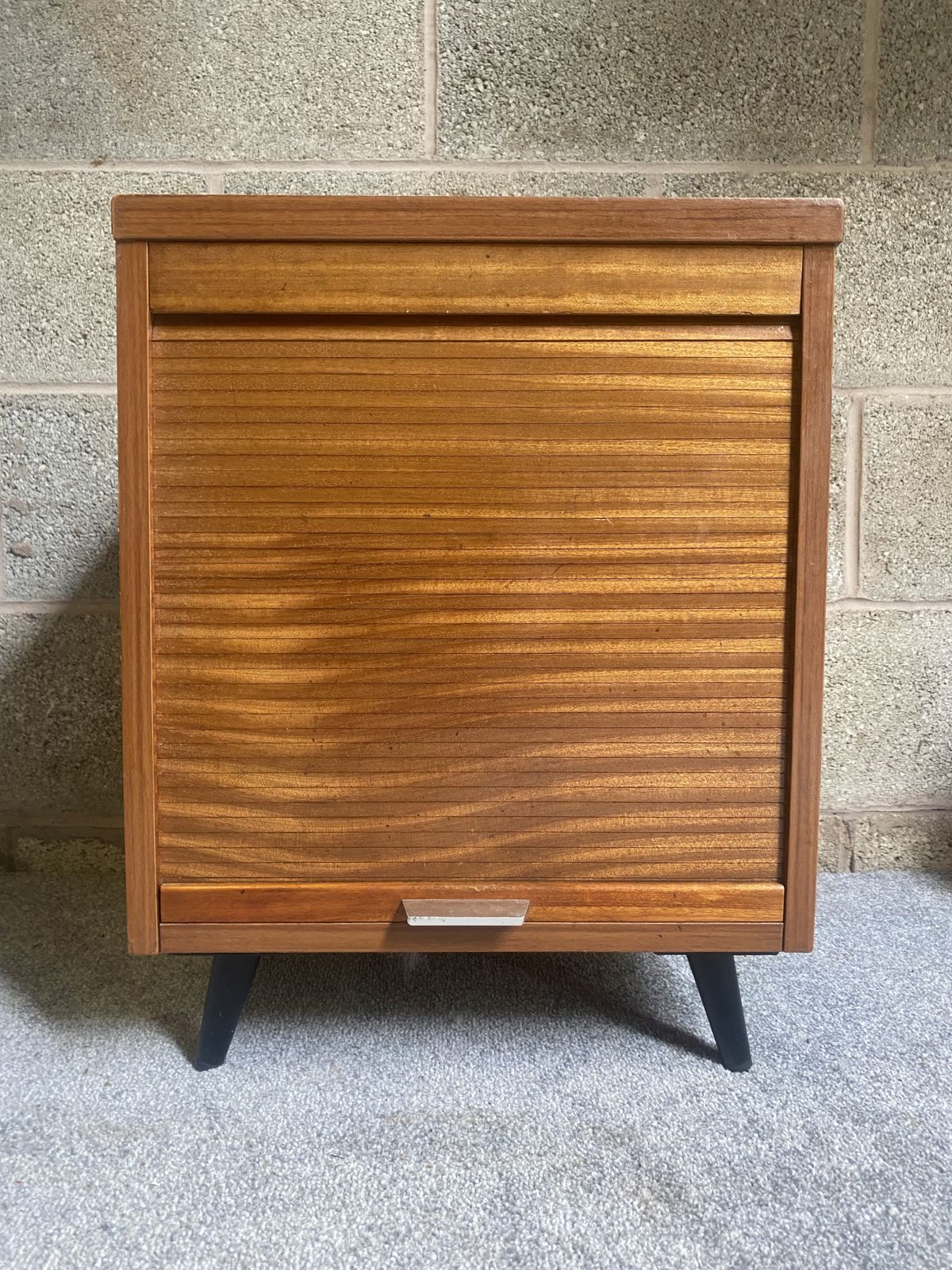 A Charming Vintage Mid Century Record Cabinet With A Tambour Front, Warm Wood Grain And Smart Tapered Legs. photo furniture